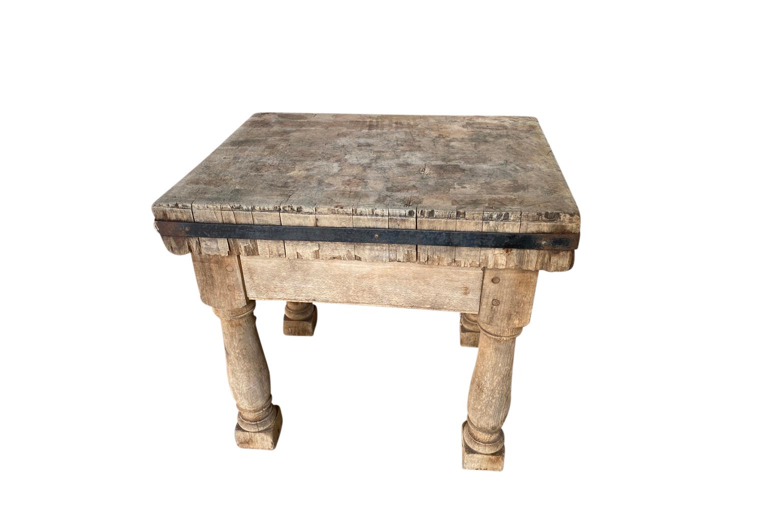 A very charming 19th century Billot - Butcher's Block from the South of France.  Soundly constructed from naturally washed beech with nicely turned legs and an iron band around the chopping block.  A wonderful kitchen island or accent table.  
