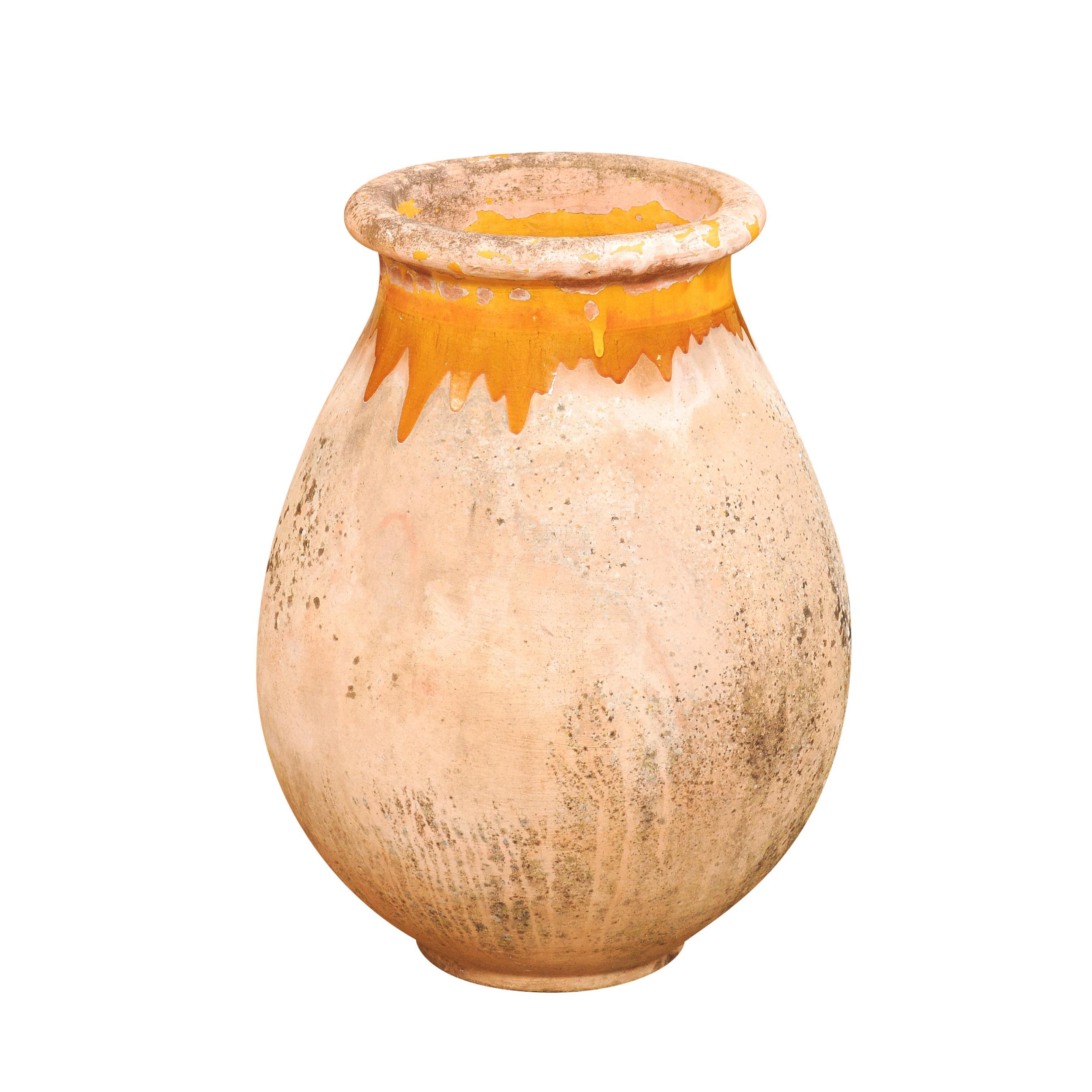 A large French Provincial Biot pottery jar from the 19th century with yellow glazed dripping and great rustic character. Elevate your garden or interior space with this French Provincial Biot pottery jar from the 19th century. With its yellow glazed