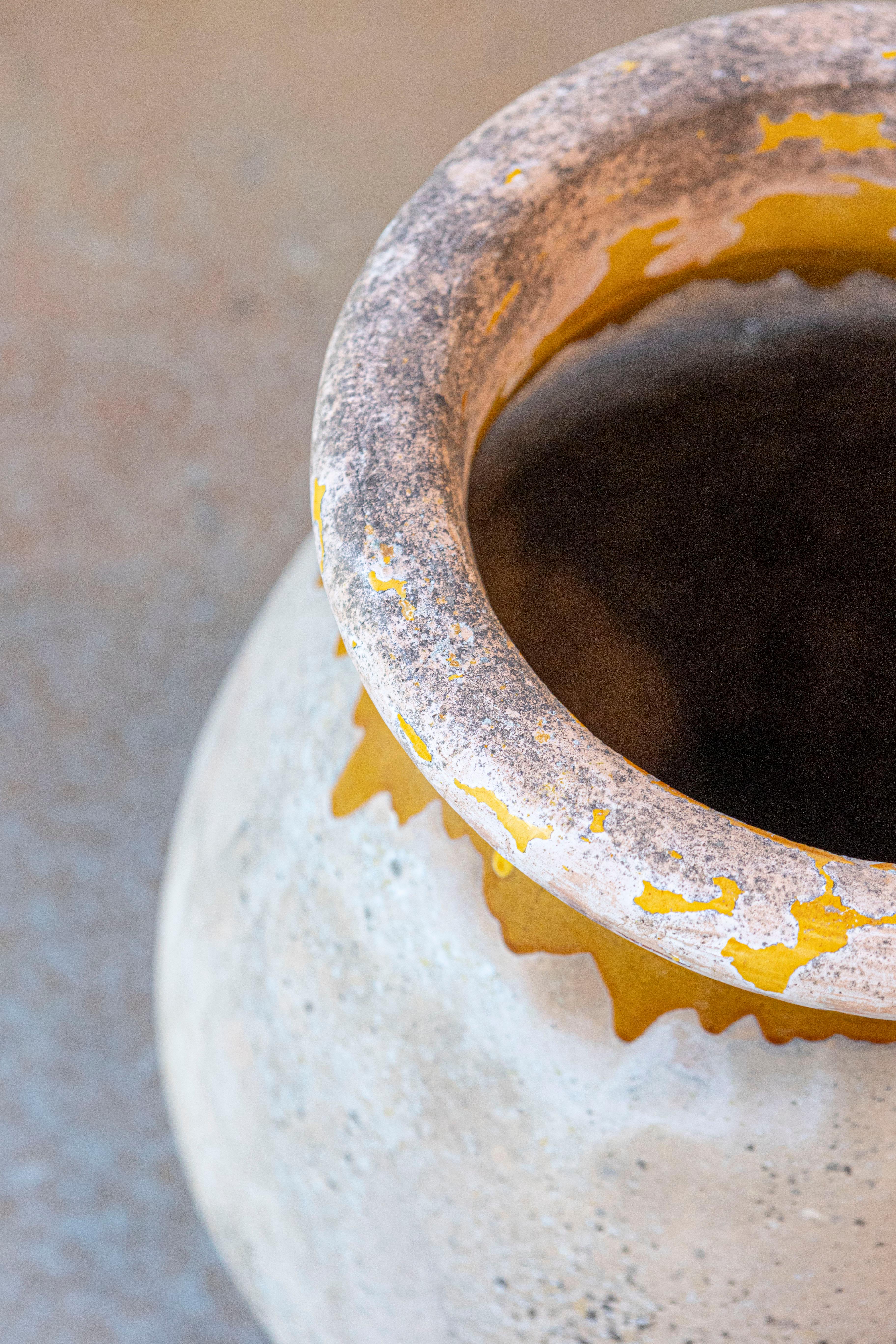 A large French Provincial Biot pottery jar from the 19th century with yellow glazed dripping and great rustic character. Elevate your garden or interior space with this French Provincial Biot pottery jar from the 19th century. With its yellow glazed
