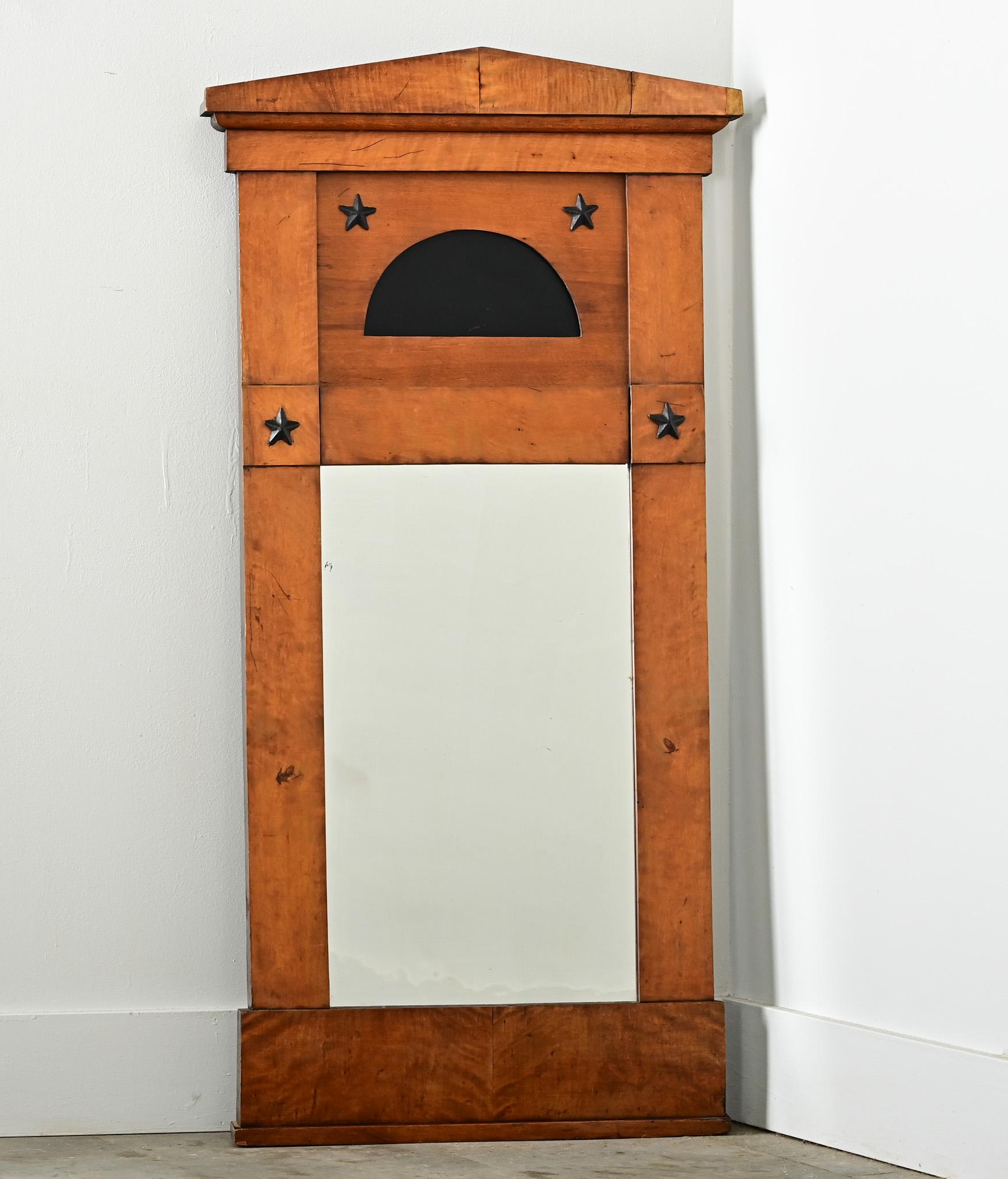 A fantastic Biedermeier period trumeau mirror from France, 19th century, made of birch wood and ebonized details around the original mirror plate. The architectural-inspired shape is crowned with a low, pitched roofline framing a central panel with