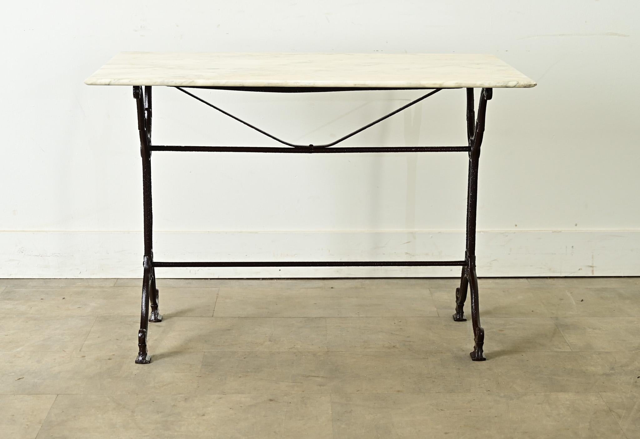A gorgeous French 19th century cast iron & marble garden dining table, for entertaining or everyday use–inside and out. The creamy white marble top shows expressive patterns of gray veining in the stone, finished with a smooth, sloping edge around