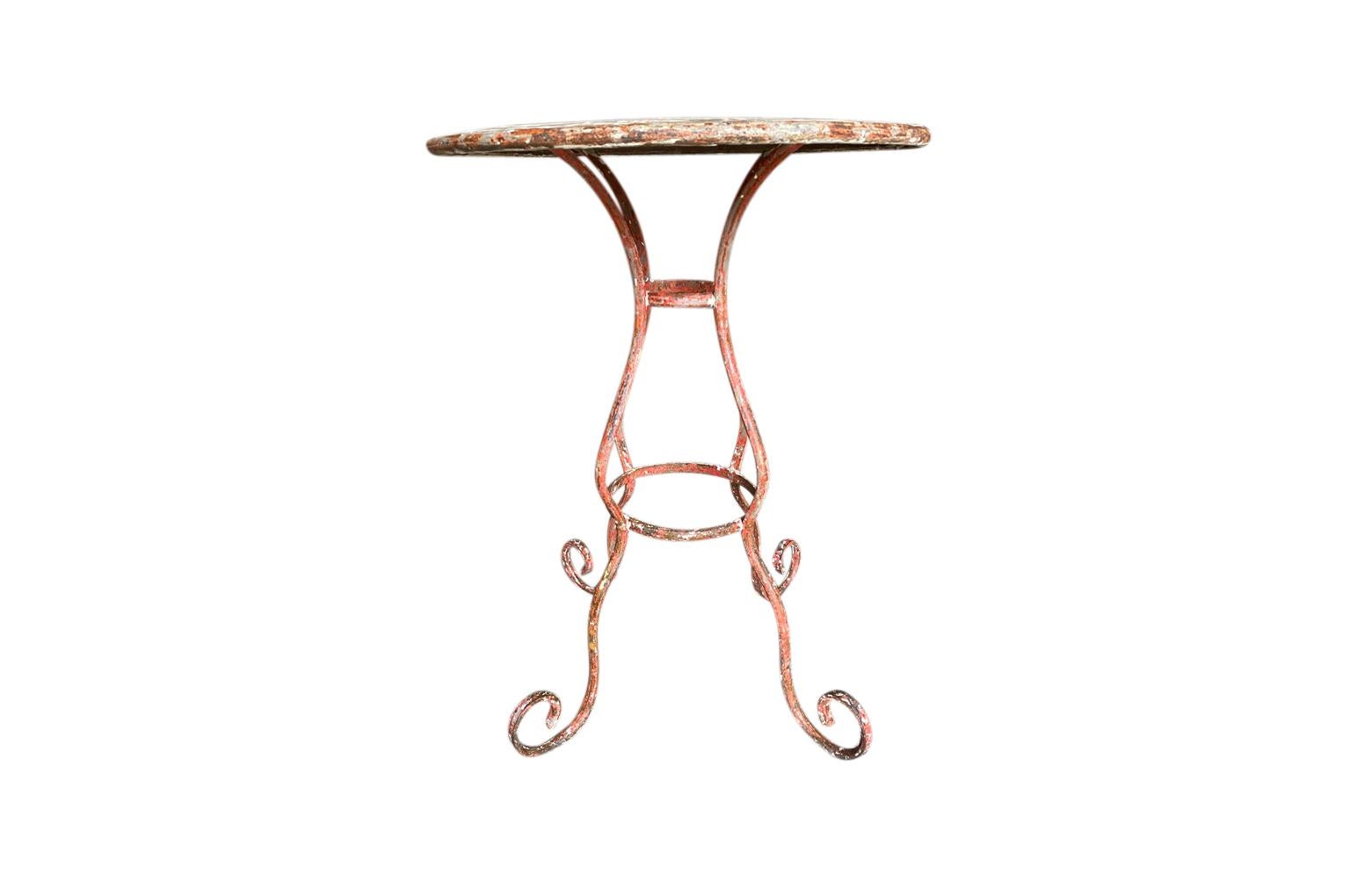 A very charming later 19th century Bistro Table - Gueridon from the South of France. Beautifully crafted in metal with a painted and scraped finish. Terrific patina. Perfect for any interior or garden.