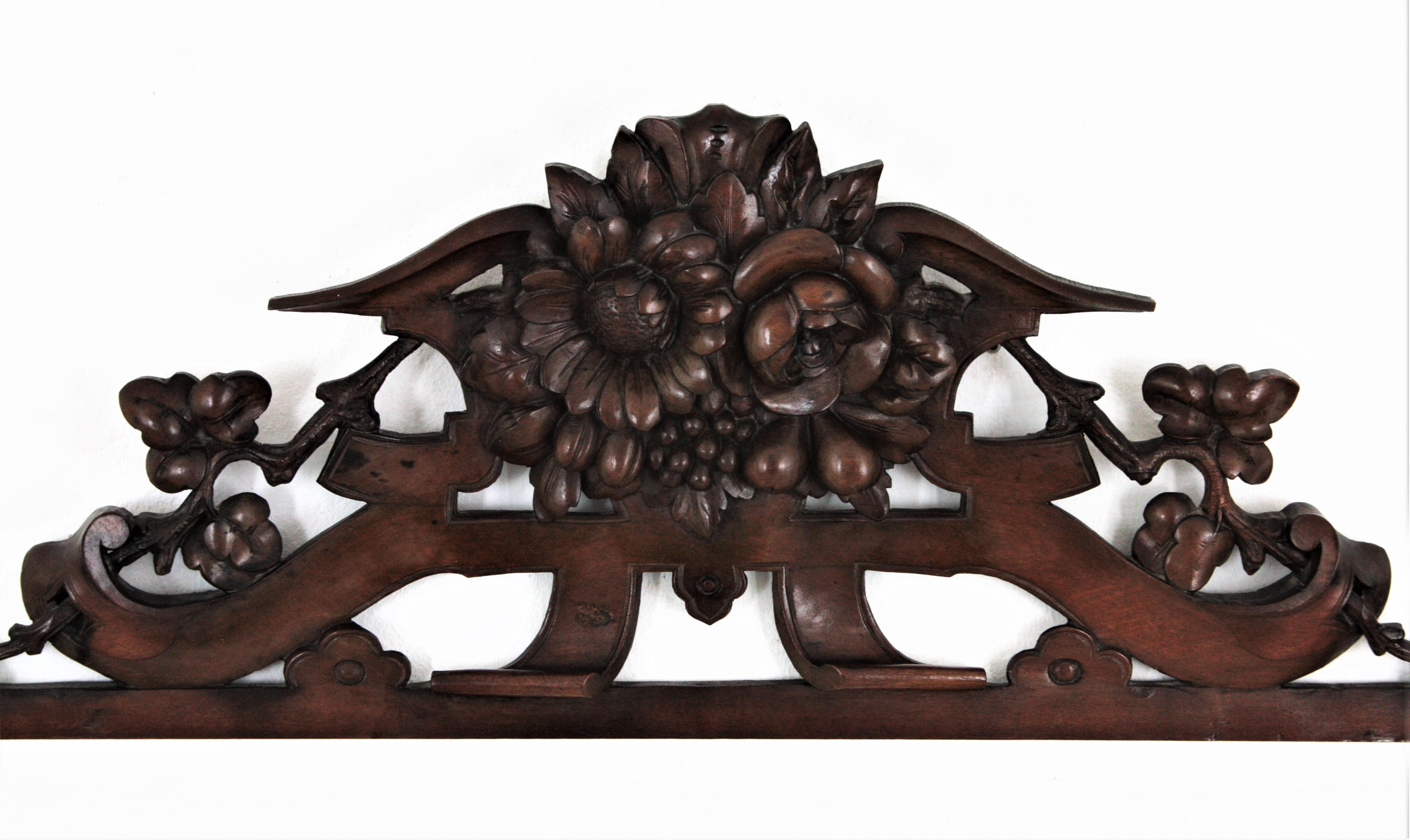 Beautiful Regency hand carved walnut wood flowers and fruits architectural pediment, France, 19th century.
This finely carved one of a kind crest or cornice features a bouquet of flowers and fruits adorned with foliate and scroll motifs: It has