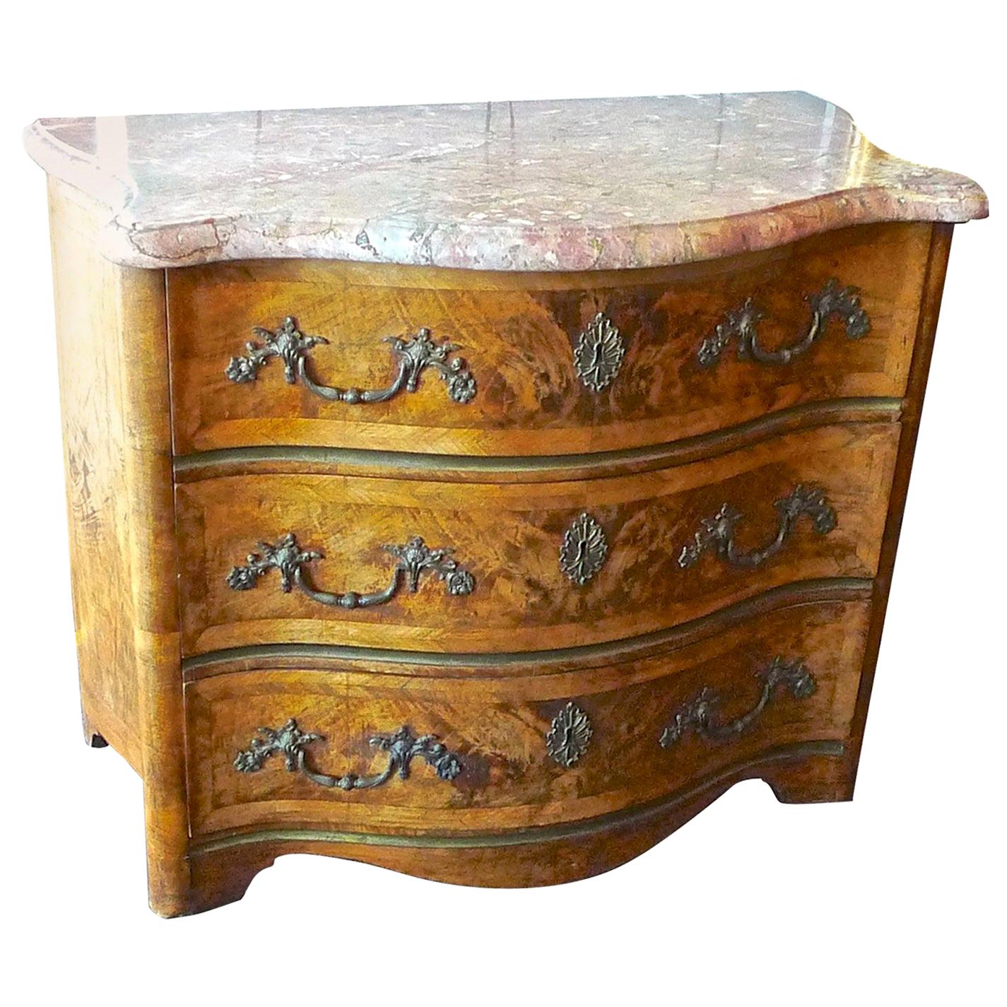 French 19th century bow-fronted burl walnut chest of drawers with a marble top and original hardware.