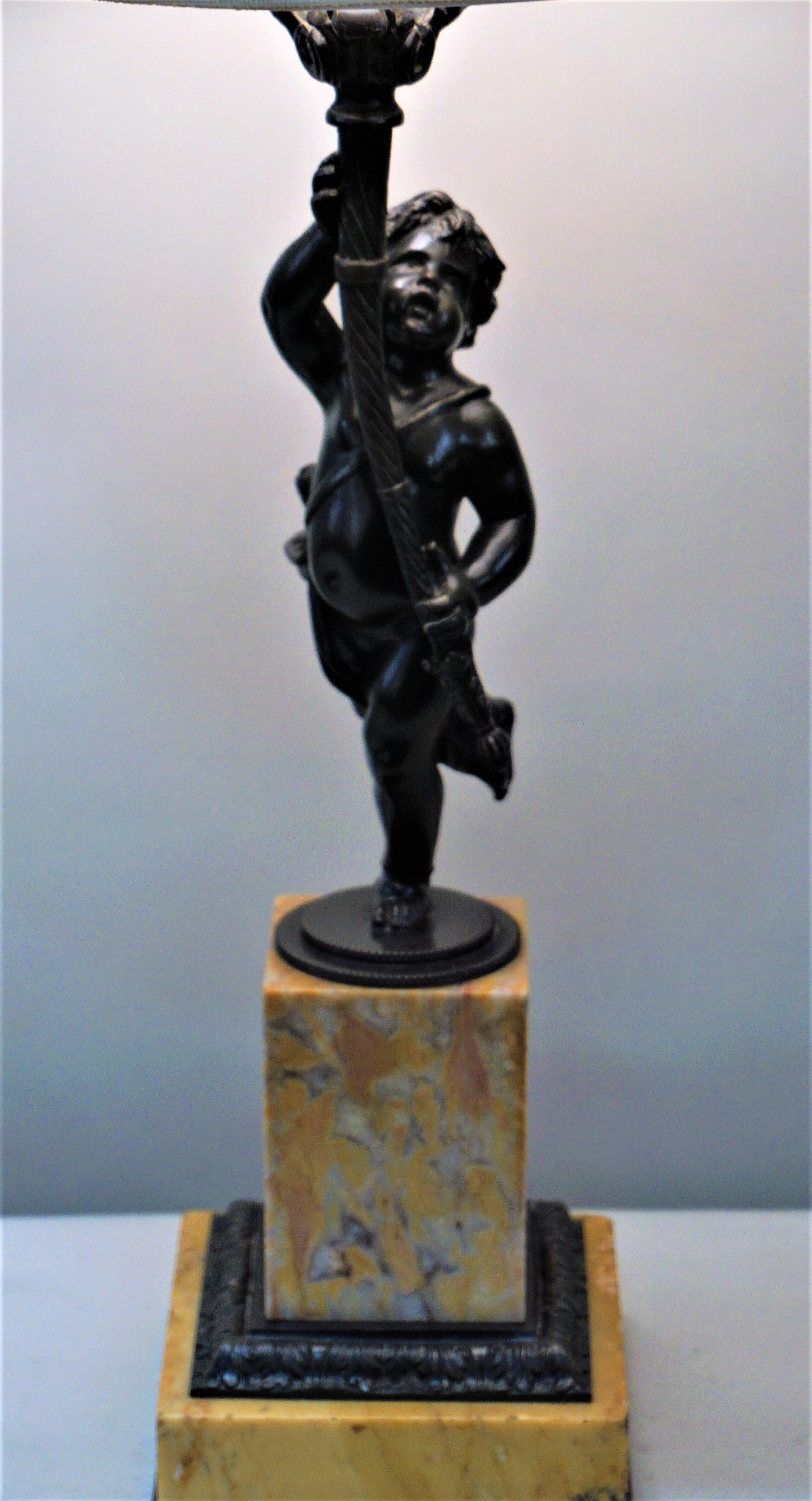 French 19th century bronze cherub over marble stand mounted in to a beautiful table lamp.