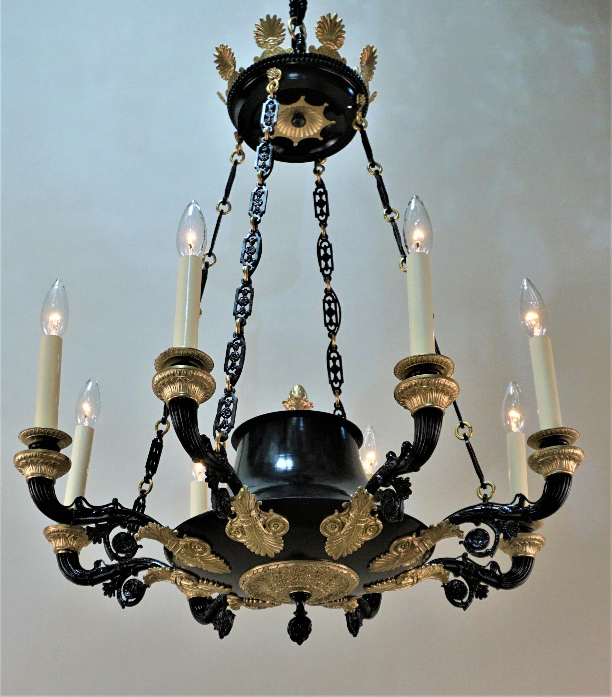 French, 19th century eight-light two color bronze empire style French chandelier.
Measures: Total height of this chandelier is 46.5