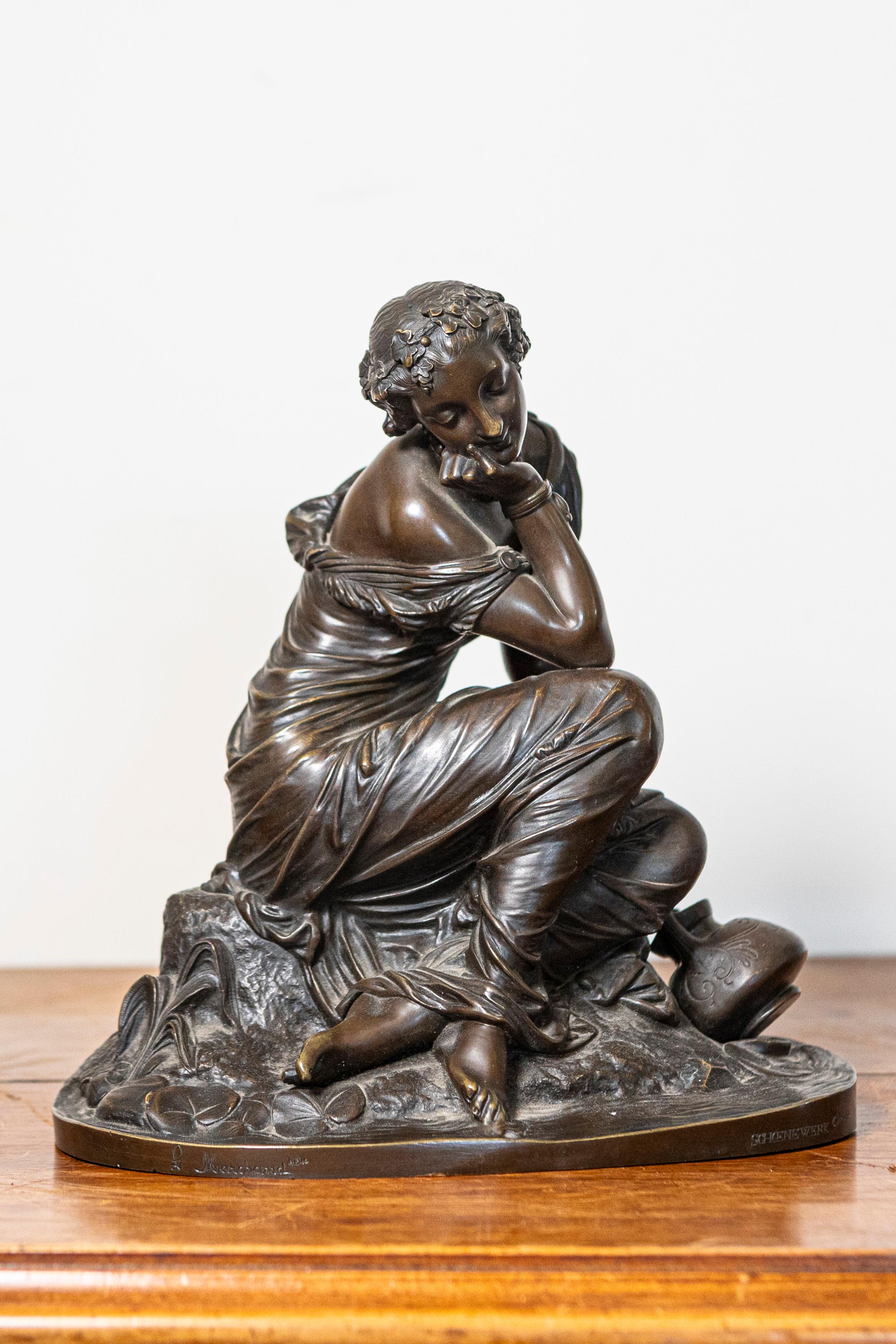 A small French bronze sculpture of a seated young maiden seated on a naturalistic base with a jug to her side, after Pierre-Alexandre Schoenewerk. This exquisite small French bronze sculpture from the late 19th century captures the serene beauty of