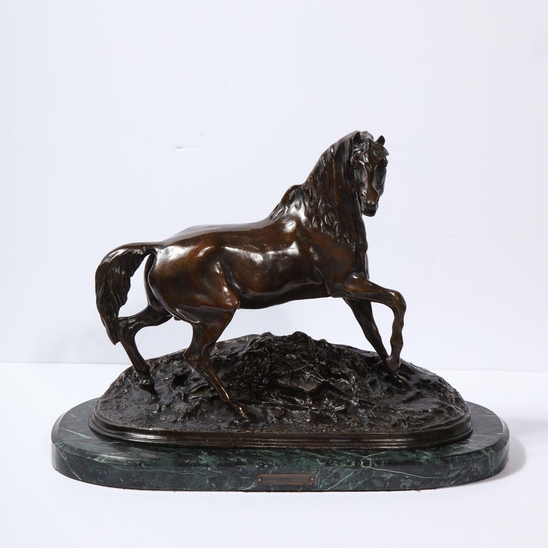 This stunning stylized bronze stallion sculpture was realized in France by the renowned sculptor Pierre-Jules Mêne (1810-1879) in the mid 19th Century. It offers a galloping horse with its head turned perched atop rocky terrain- all in beautifully