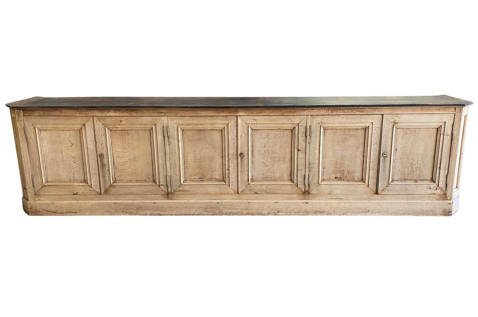 A very handsome later 19th century Buffet - Enfilade from the Provence region of France. Soundly constructed from oak with 6 doors on a plinth base and interior shelving. Nice narrow depth.