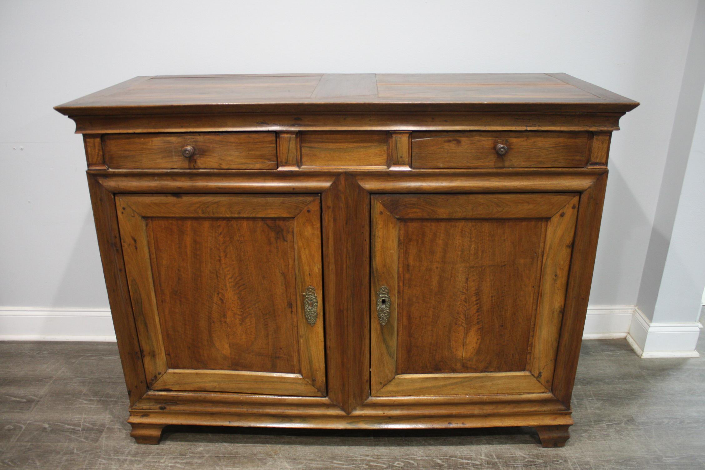 This buffet is made of walnut with the line of the Louis XIV style. Simple and rustic.