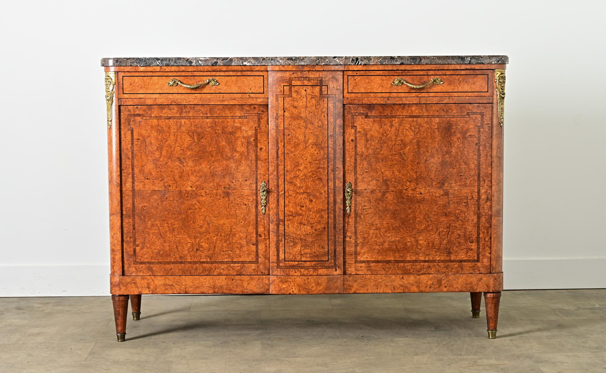 A stunning, late 19th century French buffet in a variety of exotic materials that radiates sophistication and unabashed luxury in a dining room or other living space. The top surface of brecciated marble features patches of gray and taupe stone