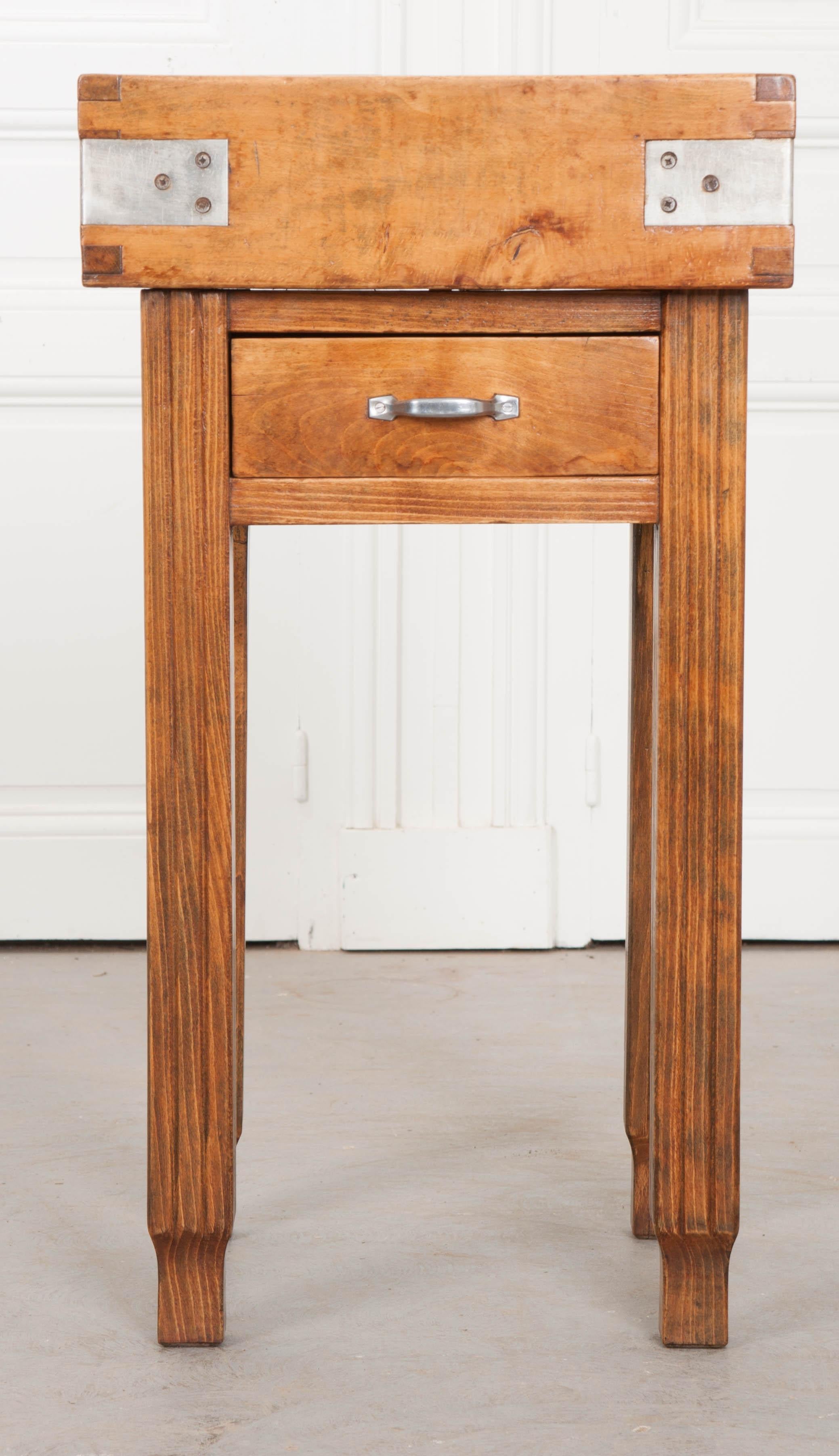 A wonderful pine table with bound butcher block top from 19th century, France. This functional antique teems with character and has acquired a phenomenal patina over its lifetime. Knife marks left from butchers and cooks long ago can still be seen