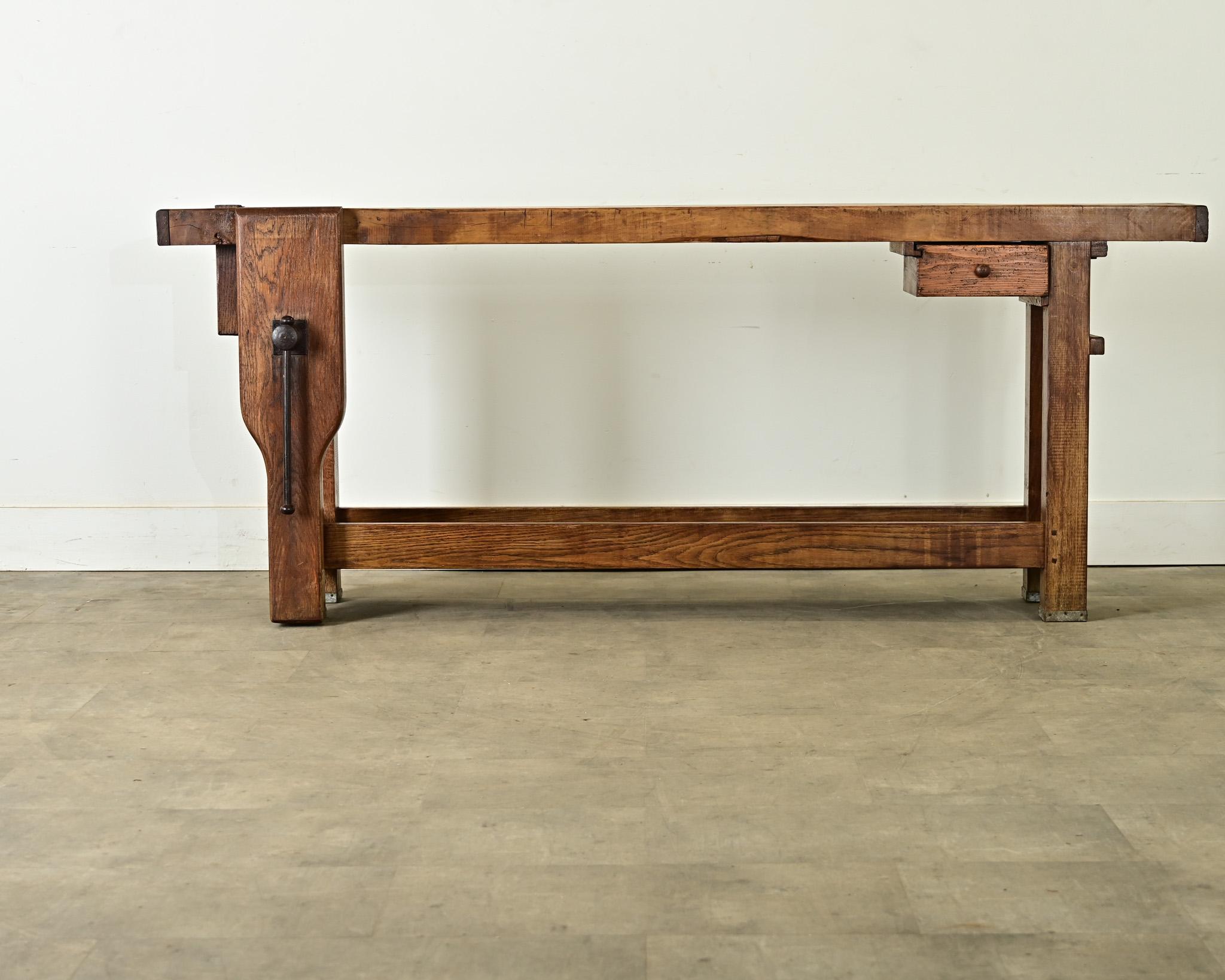 This French 19th century workbench is a fascinating relic of technology from before the assembly line, a hybrid of artisanal rusticity and industrial innovations. The richly-grained beech wood top is patinated by saws and hand tools necessary to the