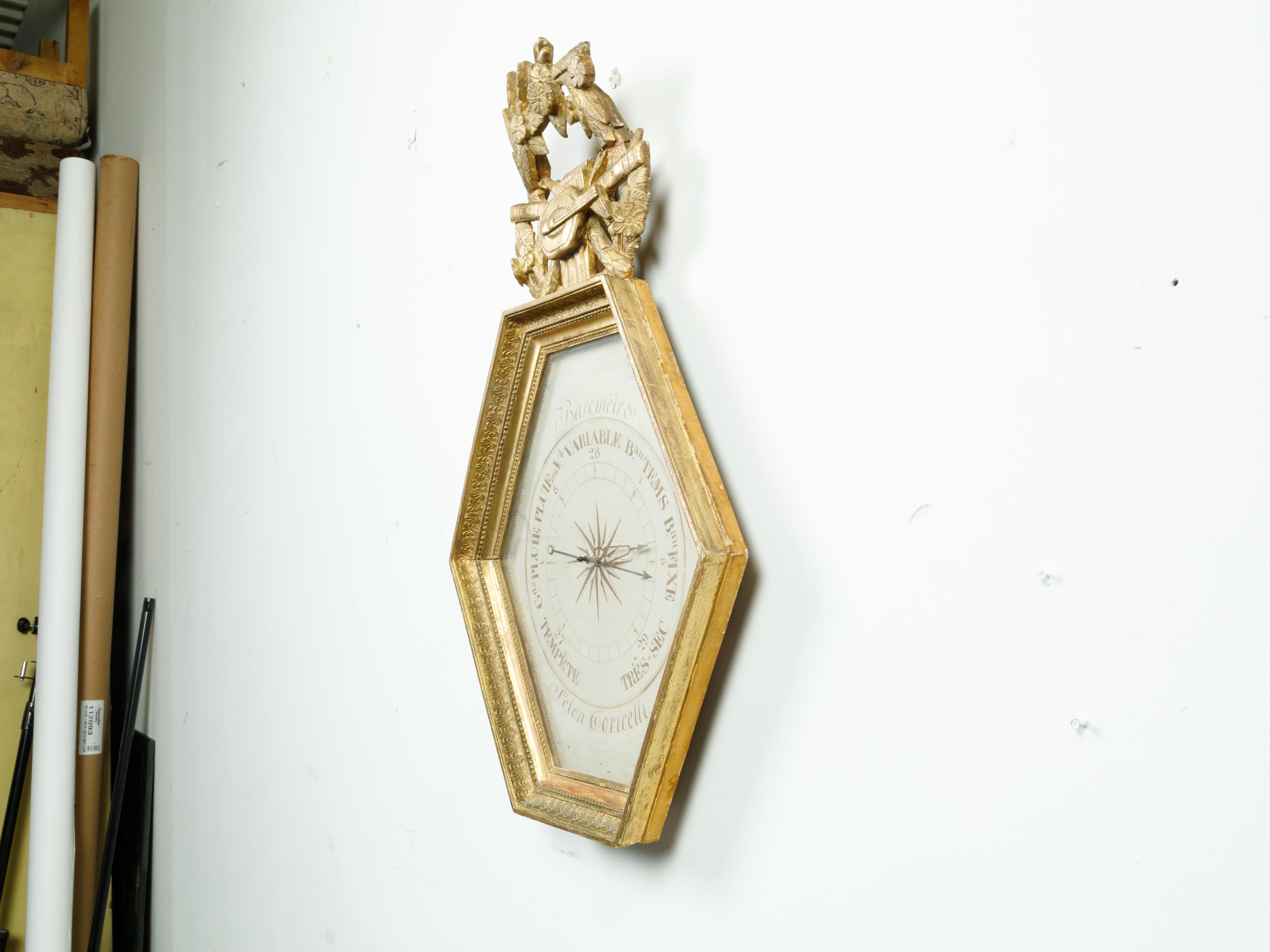 A French carved giltwood hexagonal barometer from the 19th century, after Toricelli and topped with Allegory of the Liberal Arts. Created in France during the 19th century, this giltwood barometer is adorned with a carved crest depicting musical
