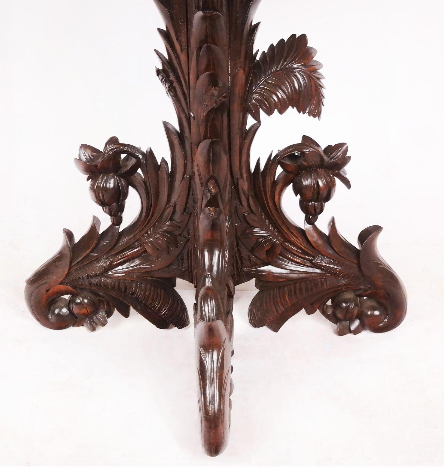 Antique carved center table made with rich walnut in France, 19th Century. Adorned with carved floral and botanical details all around the piece.
Dimensions:
29