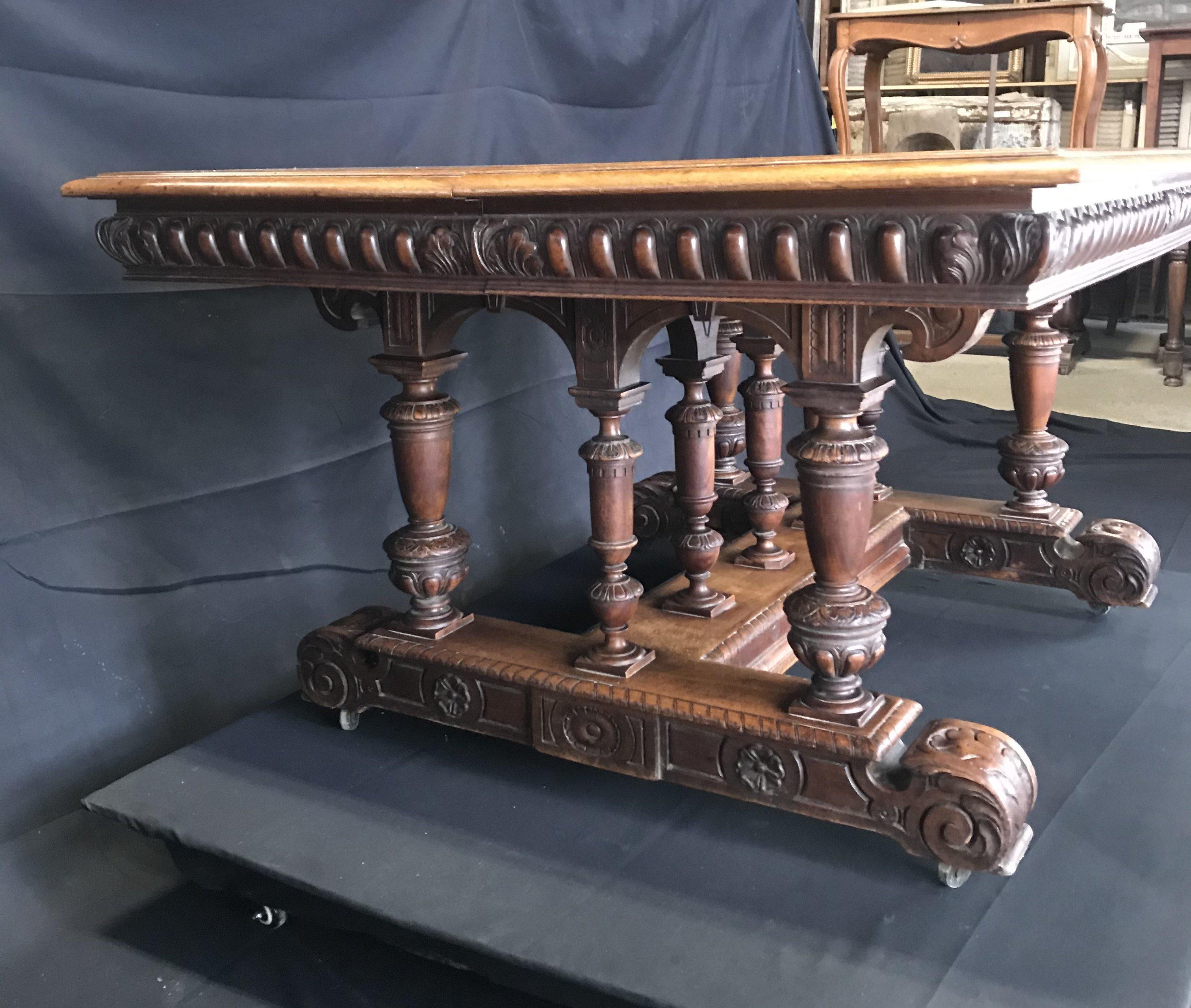Beautiful columnal carving on this classic French 19th century walnut dining table that is extendable to up to 12 feet (leaves not included). Easily moveable on its casters, this early table is sturdy and in wonderful shape. Can serve as a dining