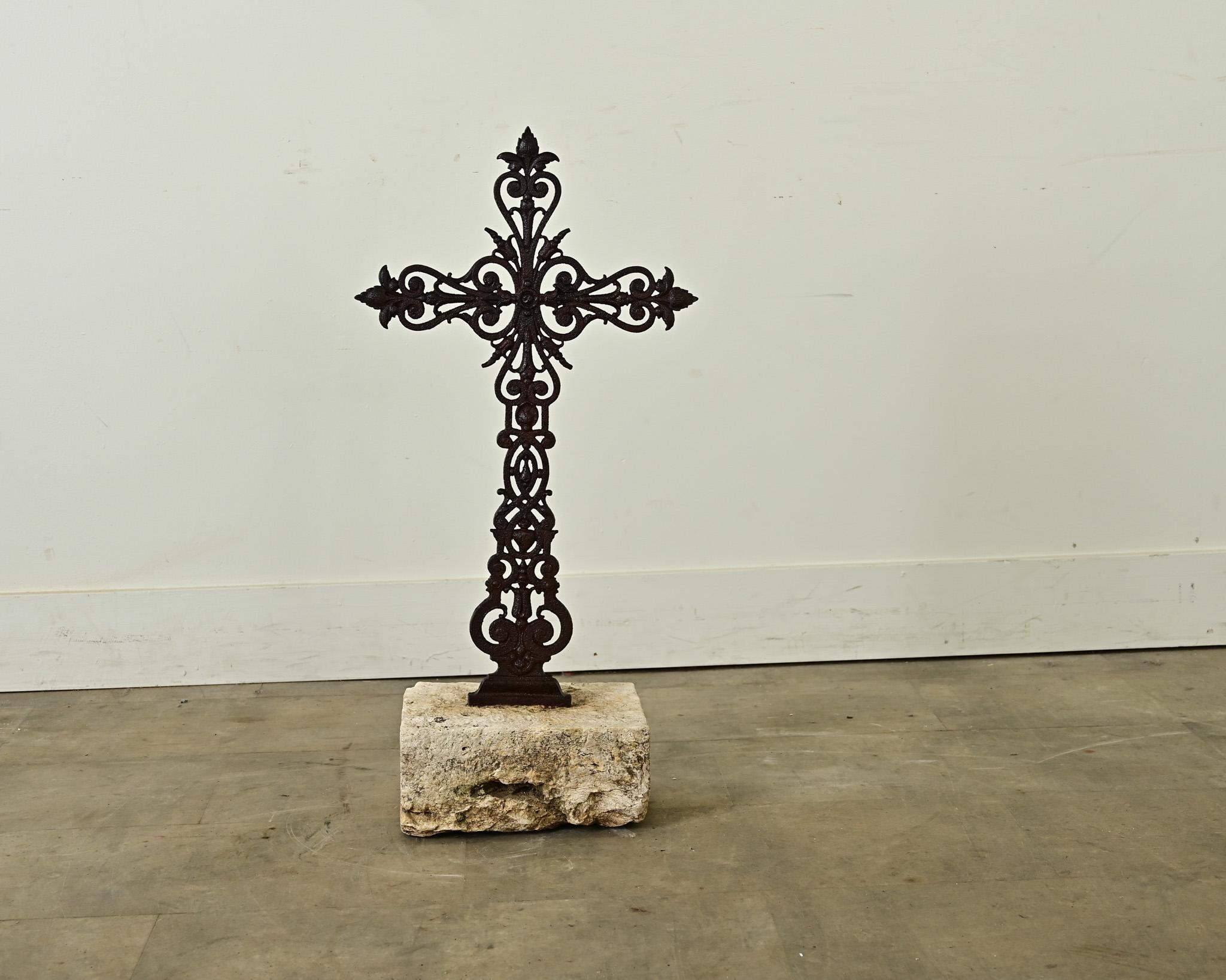 French 19th century cast iron field cross mounted in a white stone base, with elegant fleur-de-lis scrollwork and tactile patina. These are also known as a pilgrimage cross, placed strategically at the edges of churchyards, fields and vineyards to