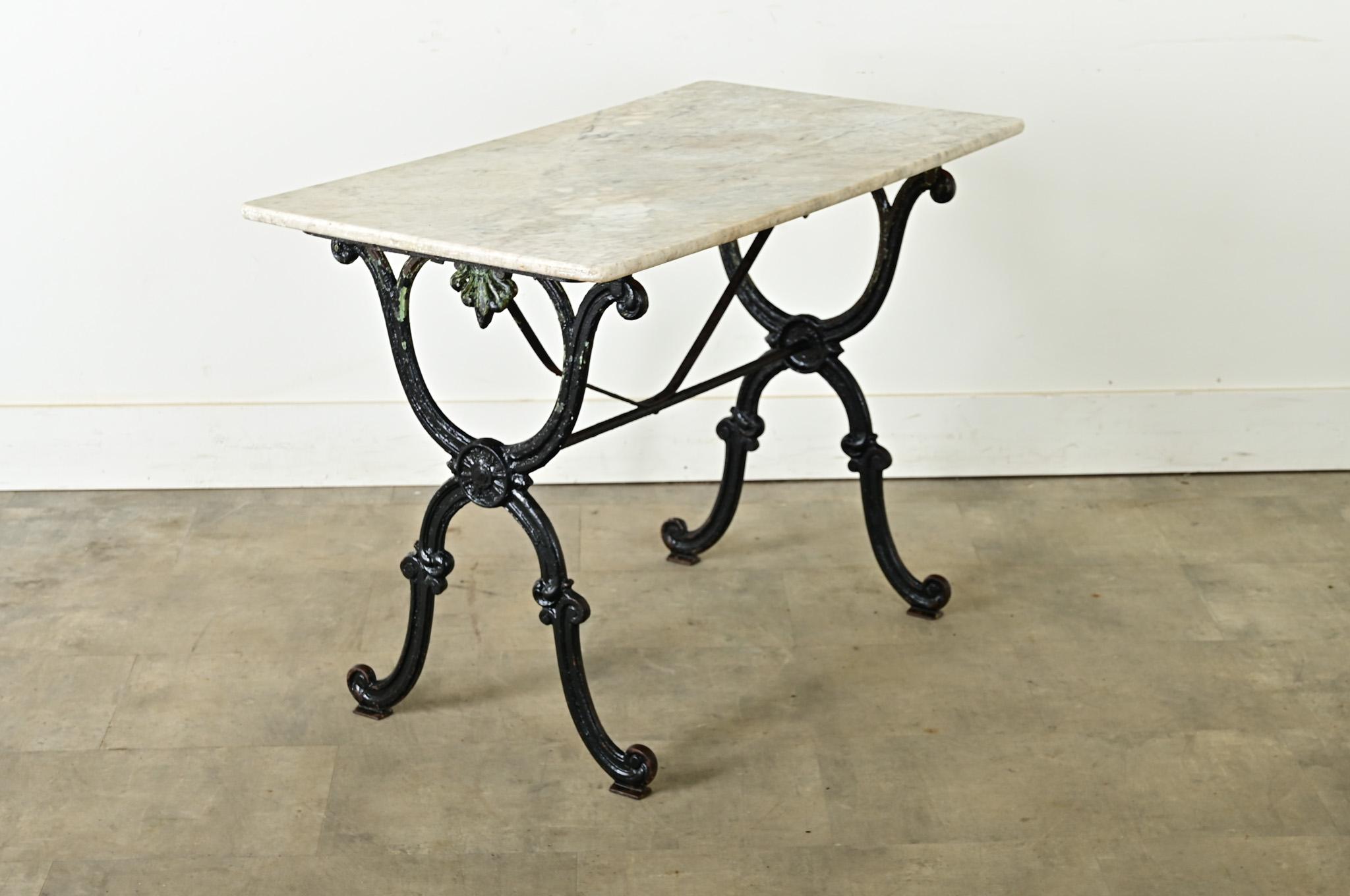 Authentique table de brasserie française, vers 1890, avec un plateau en marbre blanc sur une structure en fonte noire. Cette table de café française classique présente des éléments de design néoclassique qui apporteront une atmosphère cultivée et