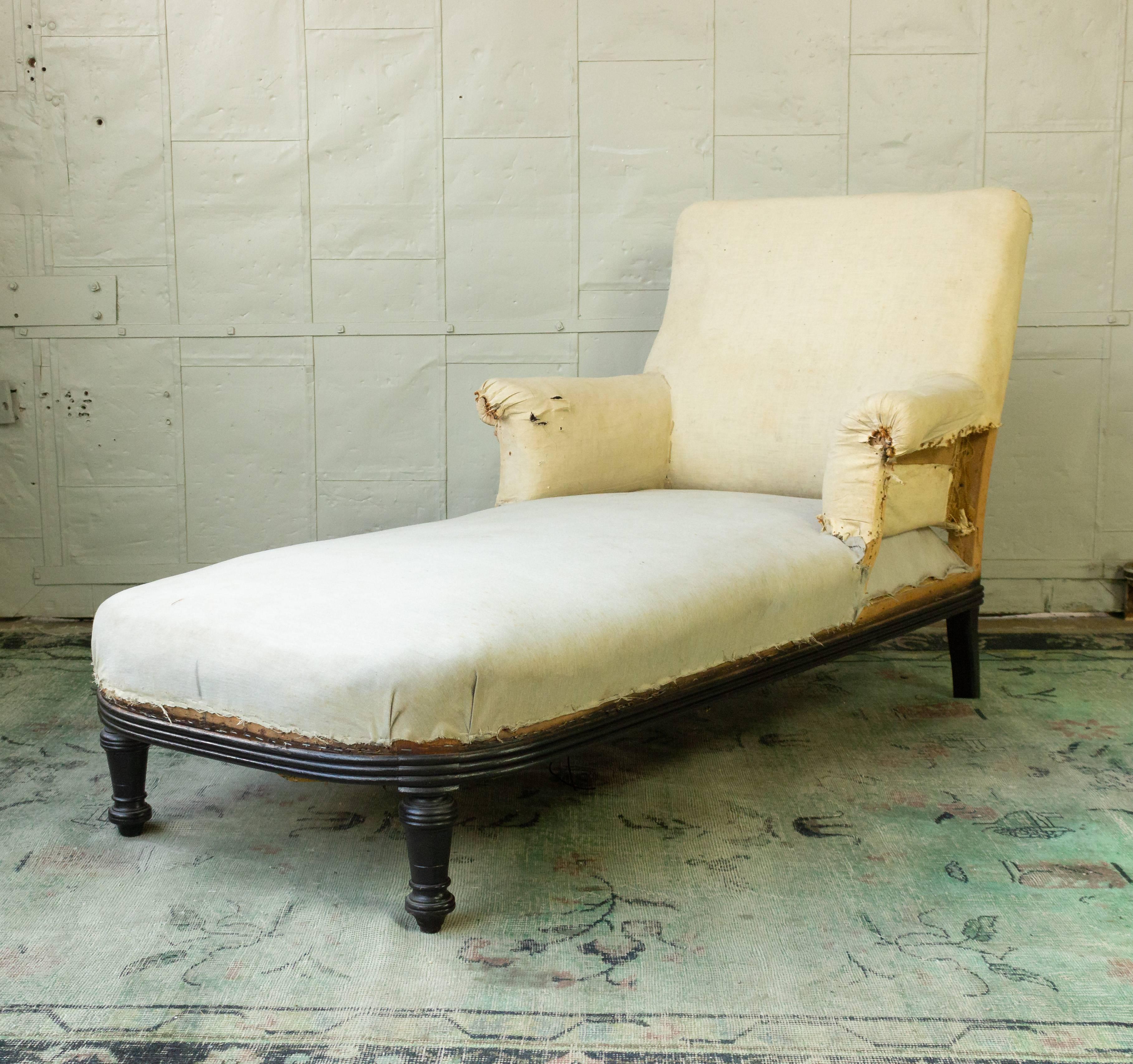 French 19th century Napoleon III chaise longue with ebonized frame. The chaise lounge has been stripped down the muslin and is ready for to be upholstered.  This piece is sold as is.