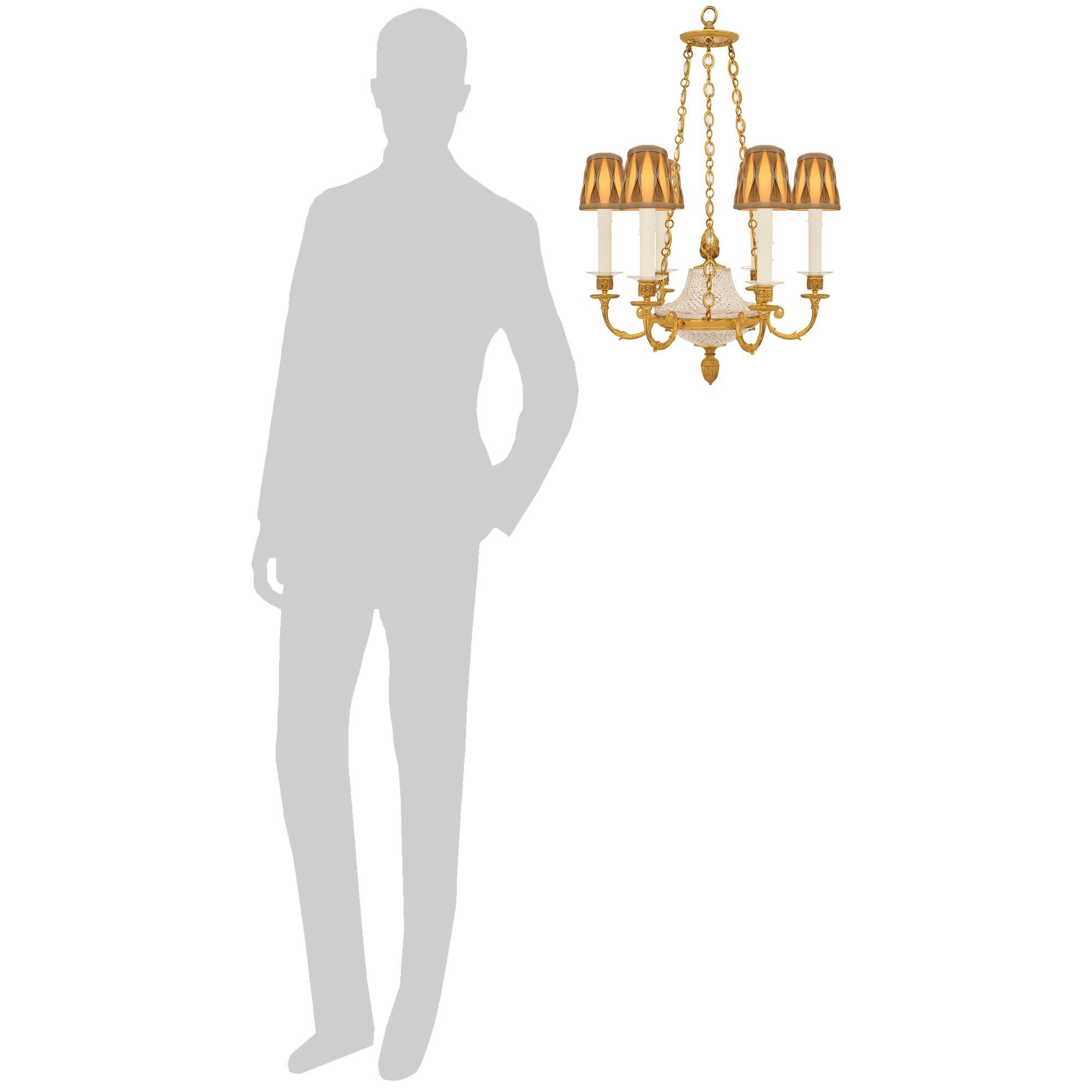 An elegant and high quality French 19th century Charles X Period Ormolu and Baccarat Crystal chandelier. This stunning six arm chandelier is centered at the bottom by an inverted finial displaying reeded, beaded and palmette designs. The finial