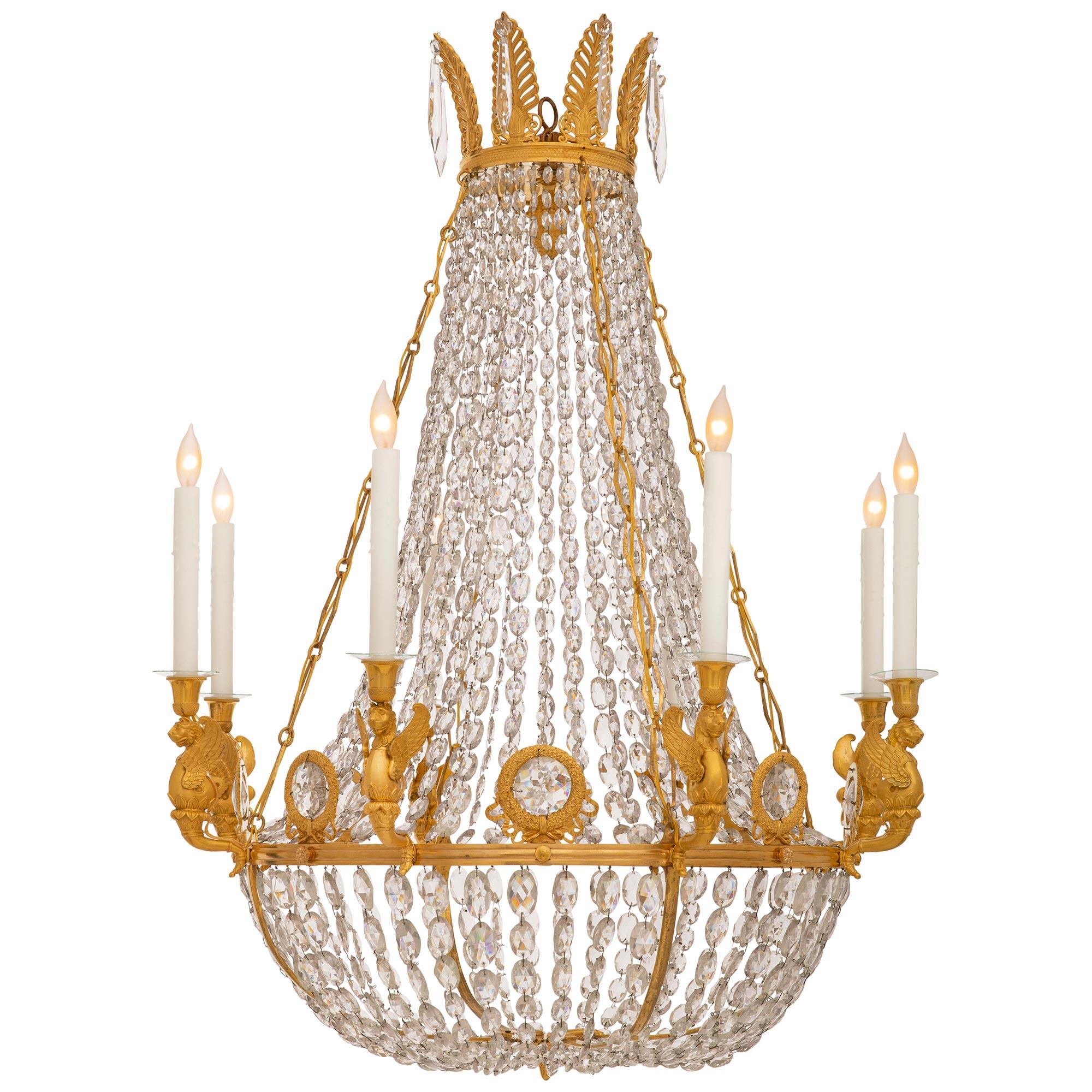 A stunning and most elegant French 19th century Charles X st. Ormolu and Crystal chandelier. This impressive eight light chandelier is centered at the bottom by a circular Ormolu reserve decorated by acanthus leaves and lattice patterns surrounding