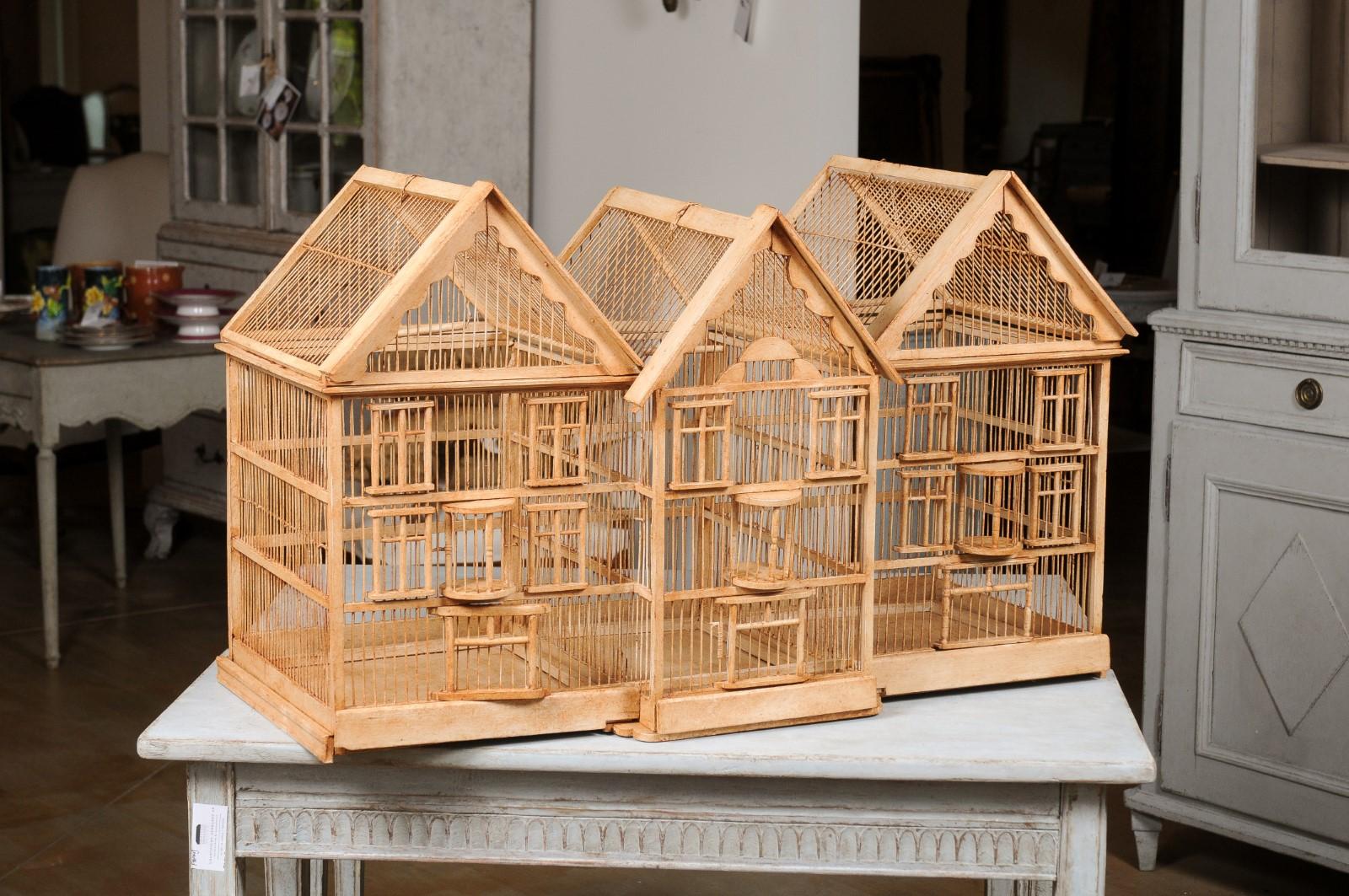 A French wooden château birdcage from the late 19th century, with slanted roofs and break front. Created in France during the later years of the 19th century, this wooden birdcage charms us with the perfect contrast between its rustic, natural