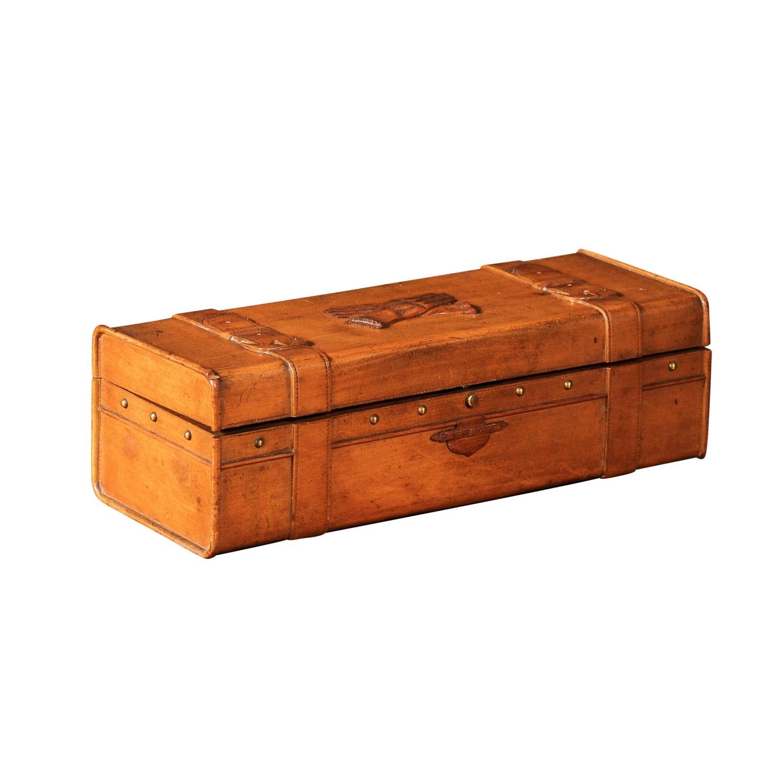 A French cherry glove box from the 19th century with two gloves carved in low relief on the lid as well as carved straps. Immerse yourself in the elegance of yesteryears with this 19th century French cherry glove box. Carved from rich, warm cherry