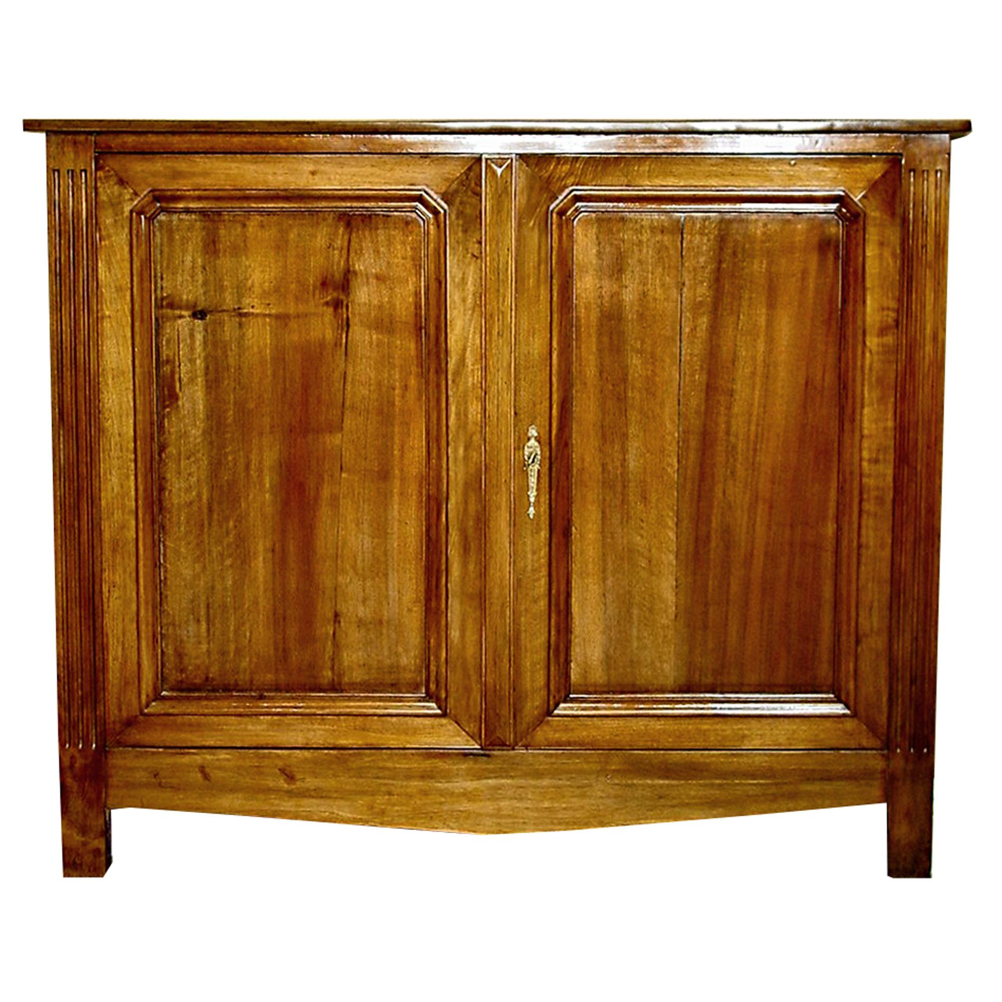 A French 19th Century French Louis XVI st. light Cherry corner cabinet with two doors. The doors with all original hardware have a rectangular moulded border. The two ends have an elegant fluted design framing the two doors. The top has a fine