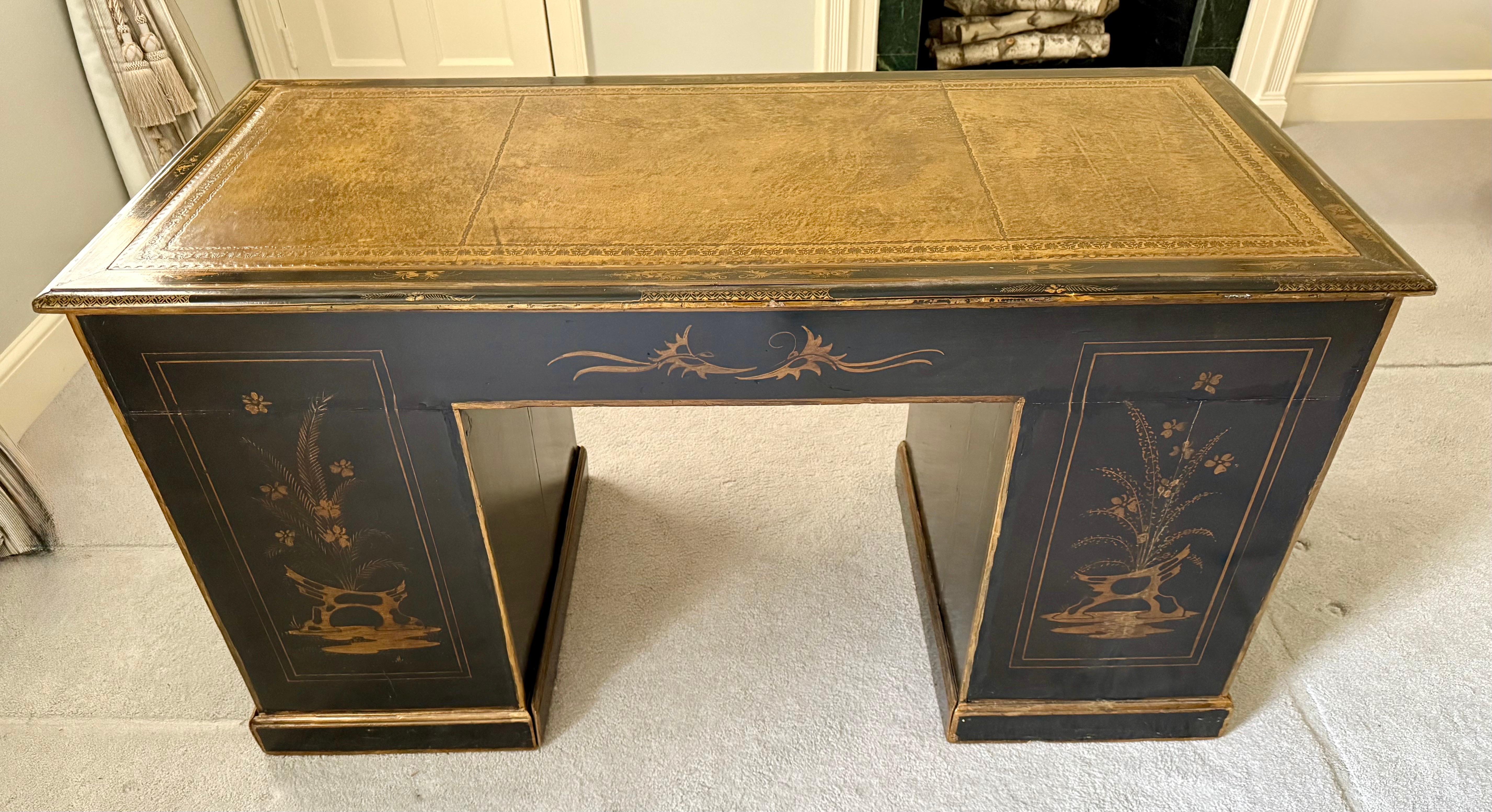 Stunning late 19th Century Chinoiserie ebonized desk with leather top and handpainted scenes throughout. Nine drawers for storage and this piece is a true work of art. Note there is also a custom protective glass top.