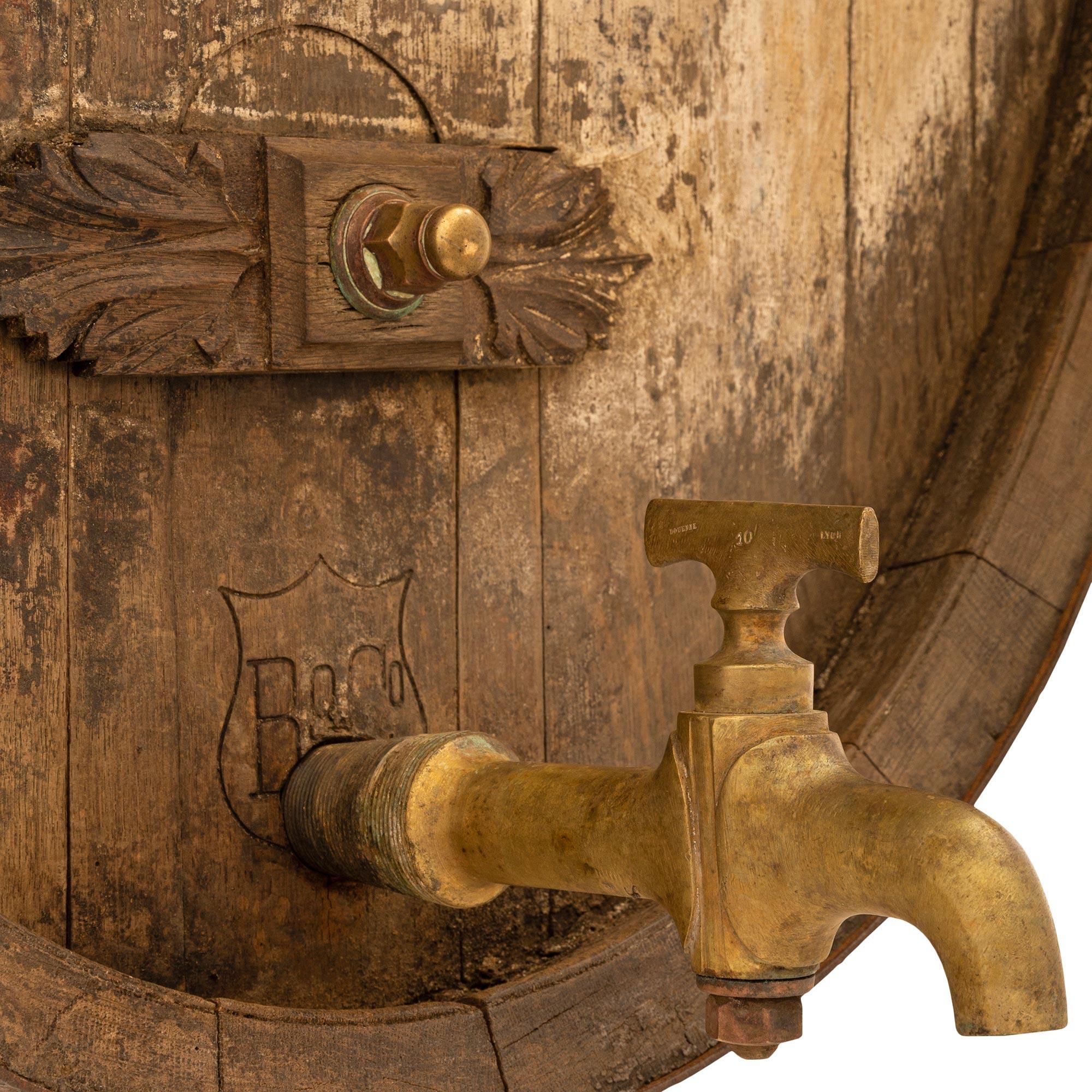 A very unique and authentic French 19th century Cognac/wine Oak barrel wall decor. This handsome barrel transformed into a wonderful wall decor has all of its original markings, identification tags, copper bands, brass faucet, and mounting brackets.