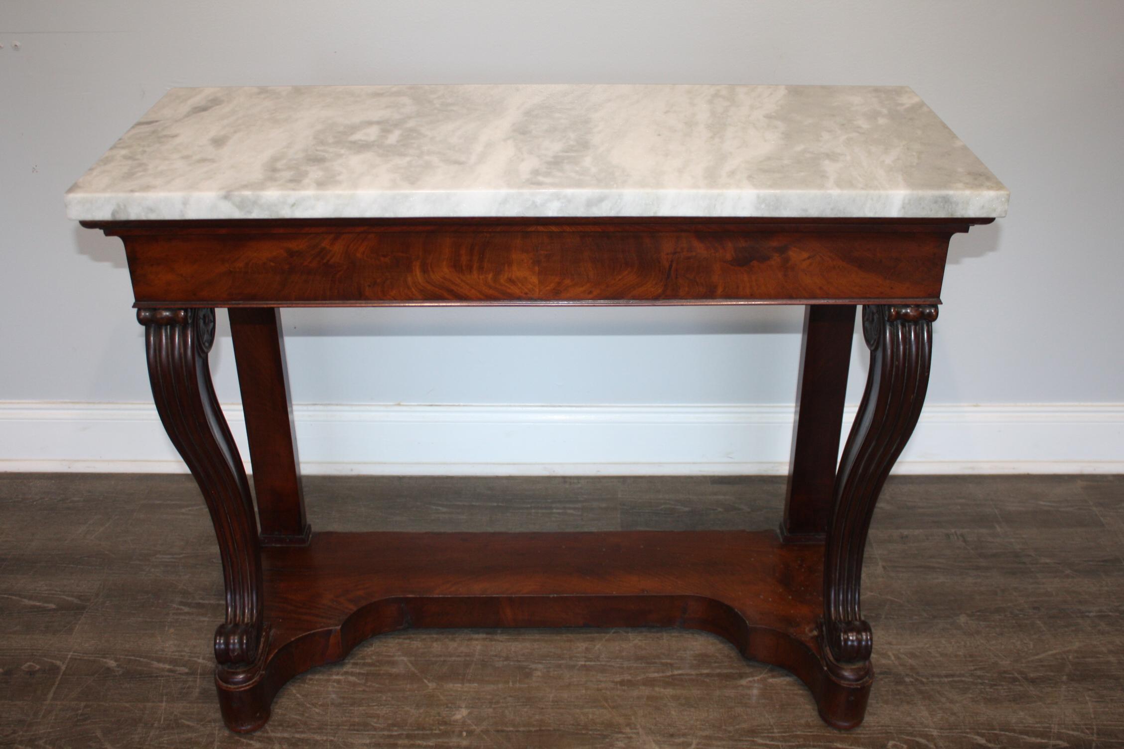 This console is made of flamed mahogany and a white marble with grey veines.