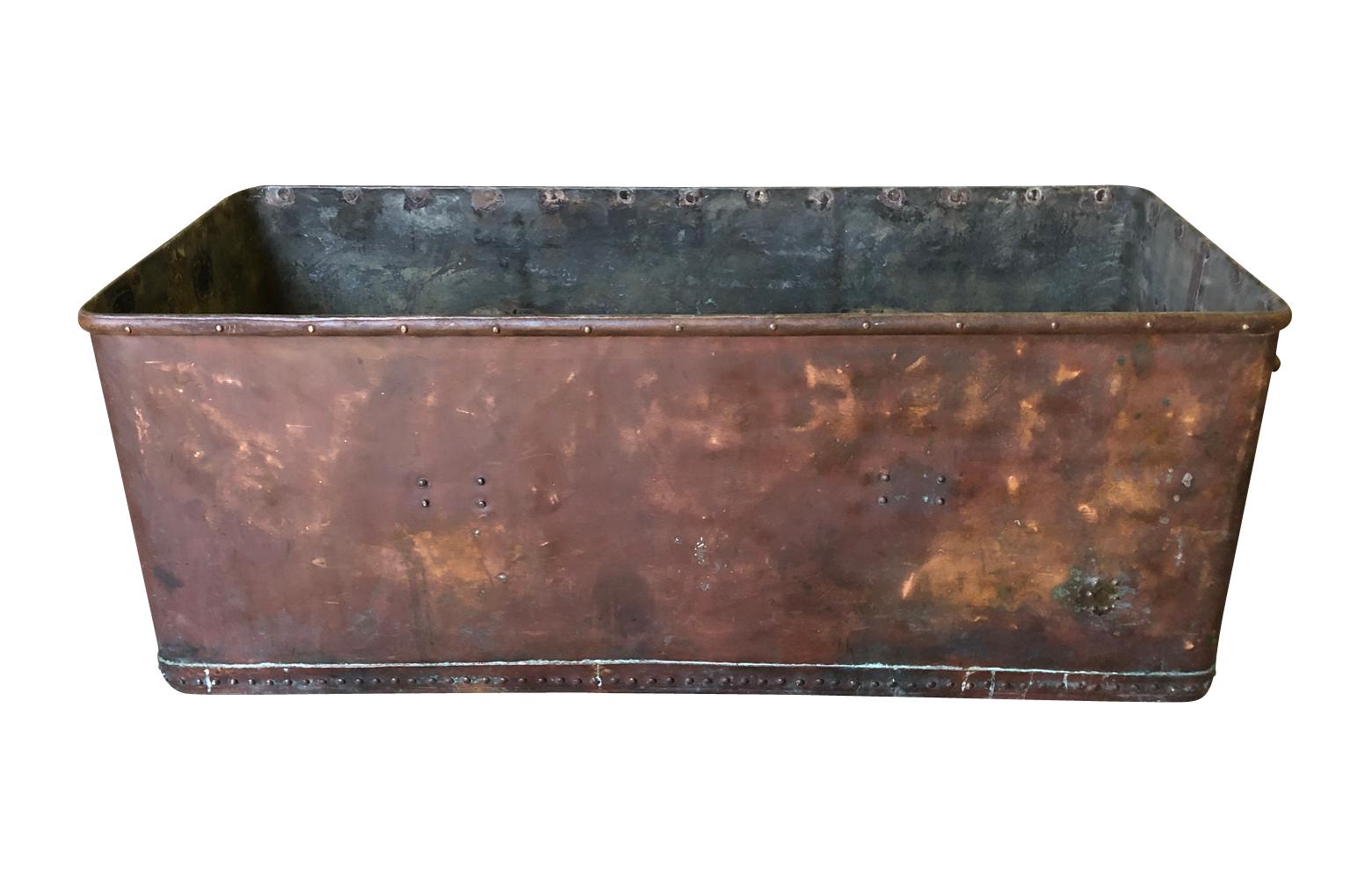 A terrific French later 19th century industrial tub or trough wonderfully constructed from heavy gauge copper.  Wonderful as a large planter or as a tub to ice down beverages for a party.  