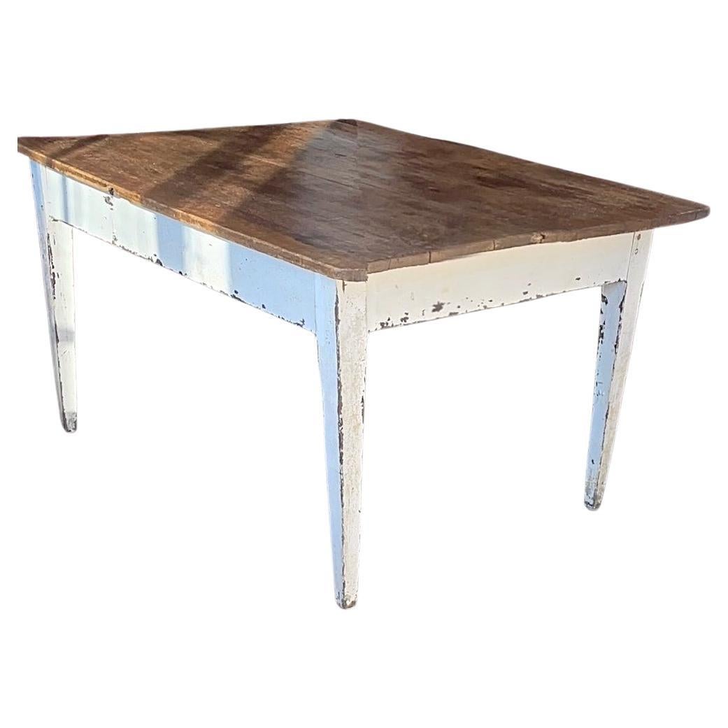 This is a fine example of a French 19thy Century breakfast table. It is quite distressed due to its aged and contant use.