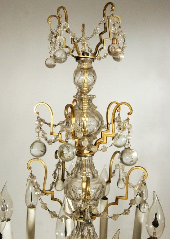 This 19th century French girandole features a hand-etched base, four tiers of brass embellishments and crystal accents. The girandole was originally converted to electric around the turn of the 20th century and has been newly rewired for safety.