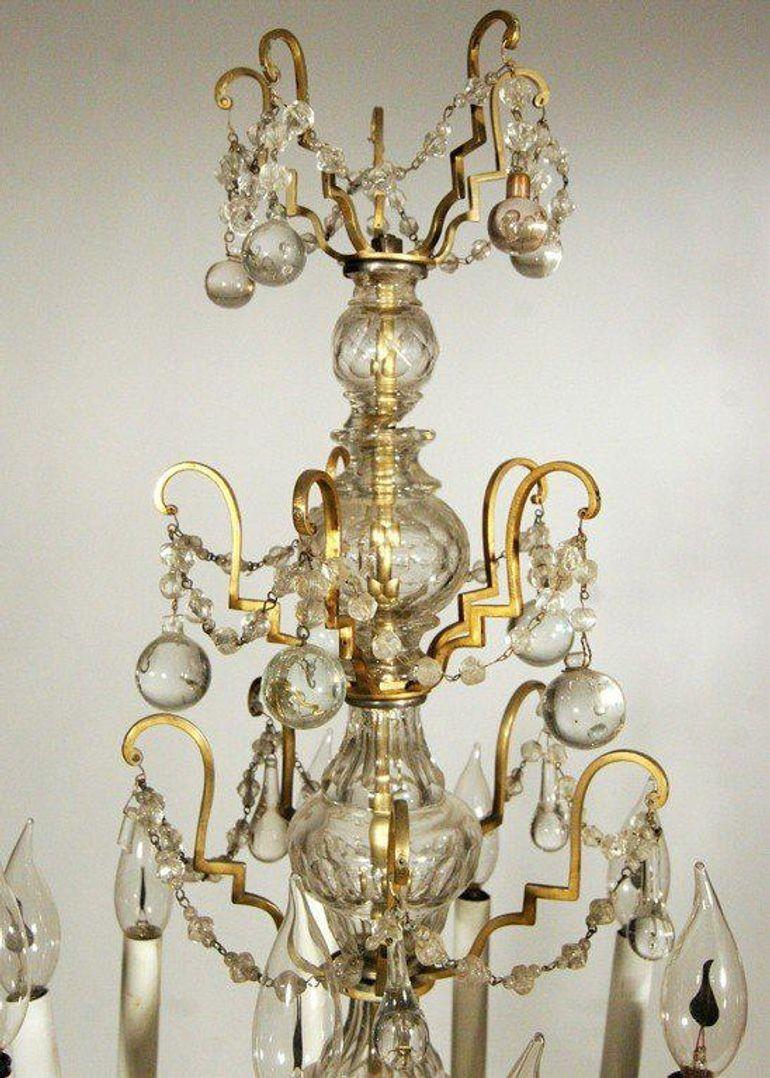 Questa girandola francese del XIX secolo presenta una base incisa a mano, quattro livelli di decorazioni in ottone e accenti di cristallo. La girandola è stata originariamente convertita all'elettricità intorno all'inizio del XX secolo ed è stata