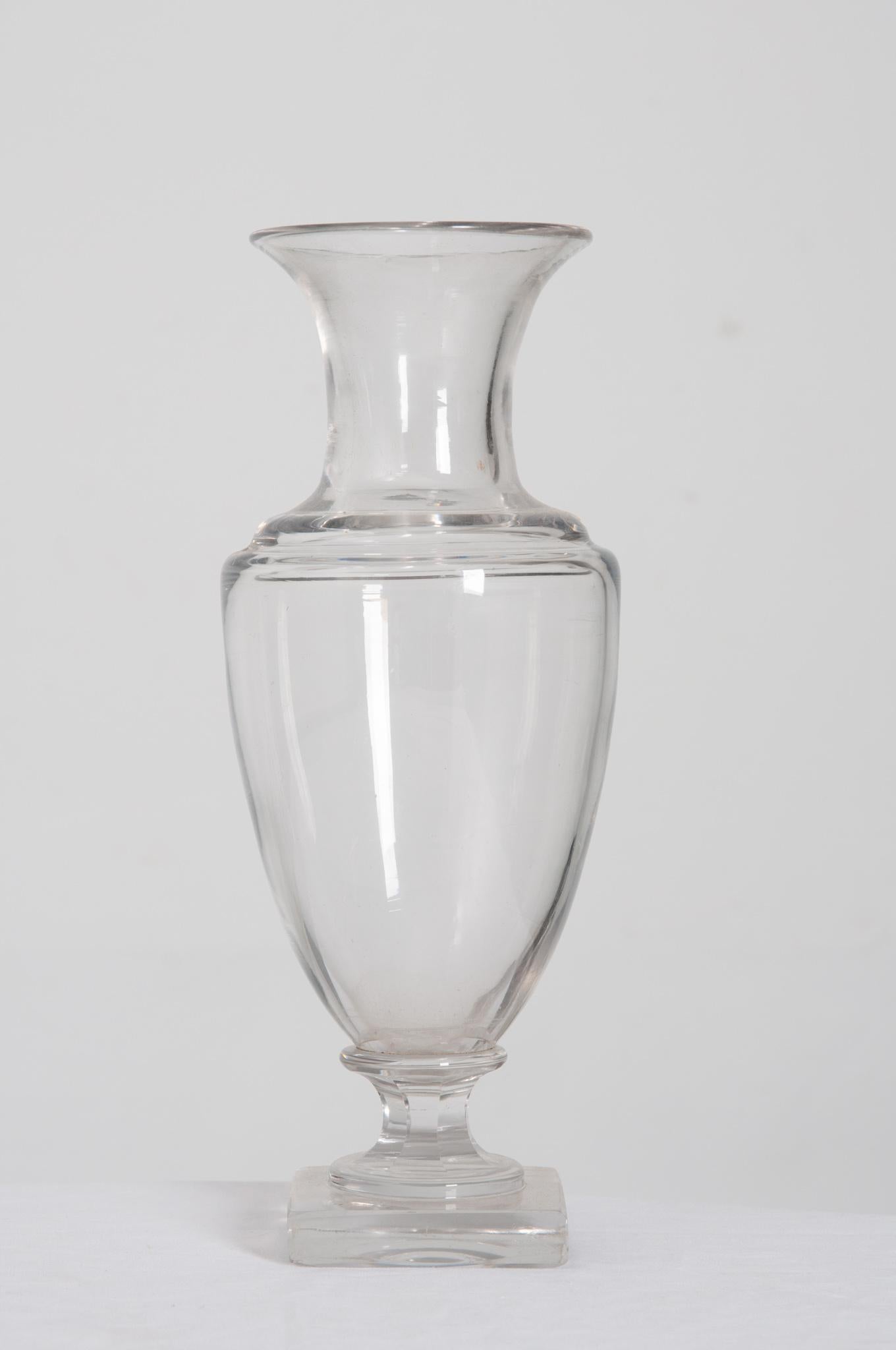 This fabulous crystal vase was made in 19th century France! Its beautiful form and clear glass make it easy to incorporate it into any existing decor. This urn shaped vase is quite heavy, a testament to the quality of glass. Urn-like in shape the