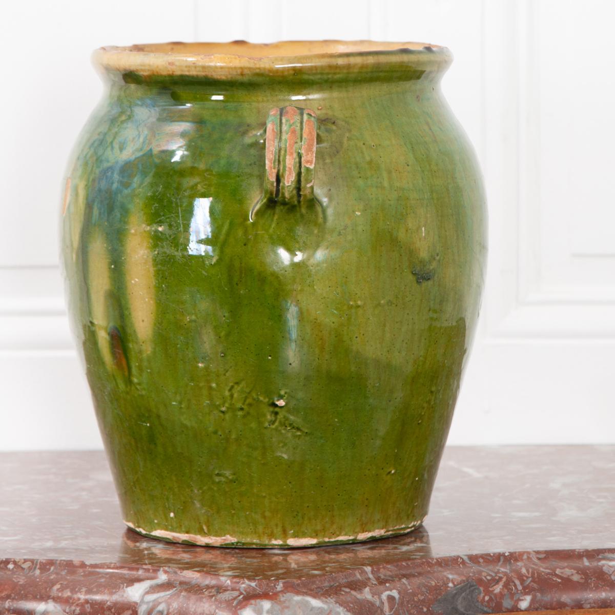 Dark green glazed confit jar for storing meat and fat. Most of these jars are only glazed on the top half of the exterior and on the inside, but this jar is fully glazed except the bottom. While the exterior is dark green, the interior is glazed in