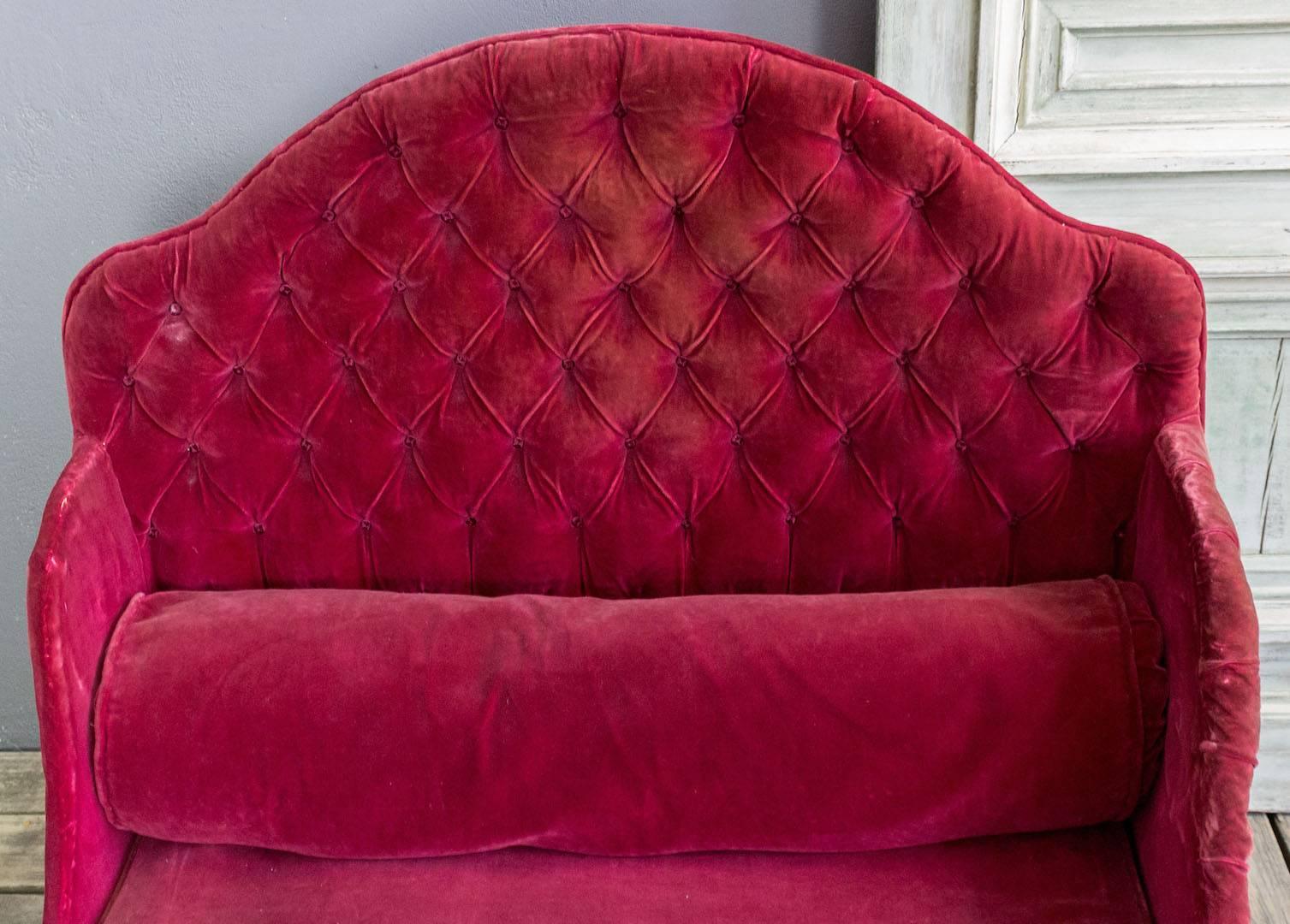 French 19th century iron bed upholstered with tufted red velvet.