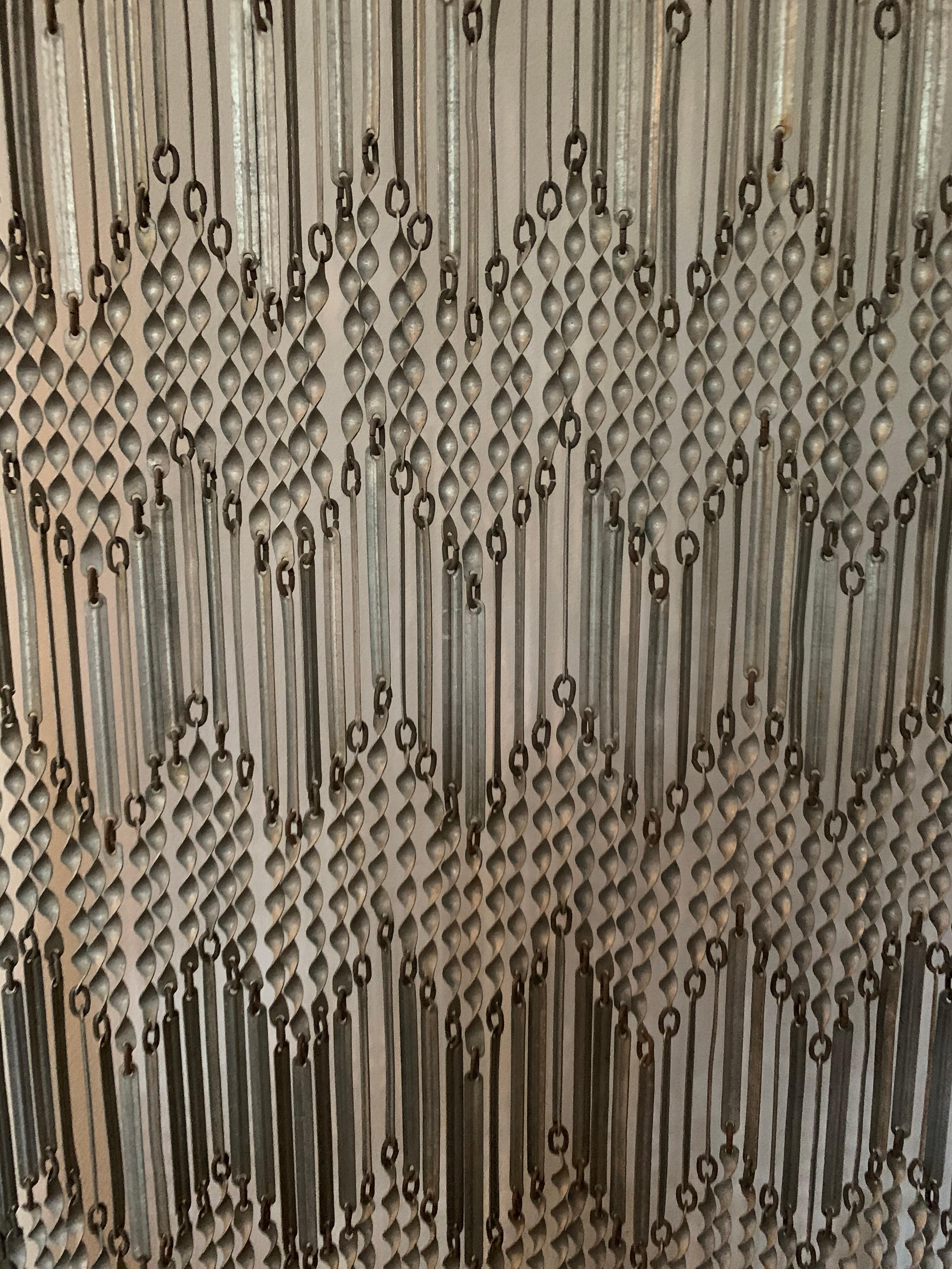 French early 20th century decorative screen. Custom made wood framed metal screen with geometric repeating pattern from top to bottom. Can be used as a partition or room divider.

Property from esteemed interior designer Juan Montoya. Juan Montoya