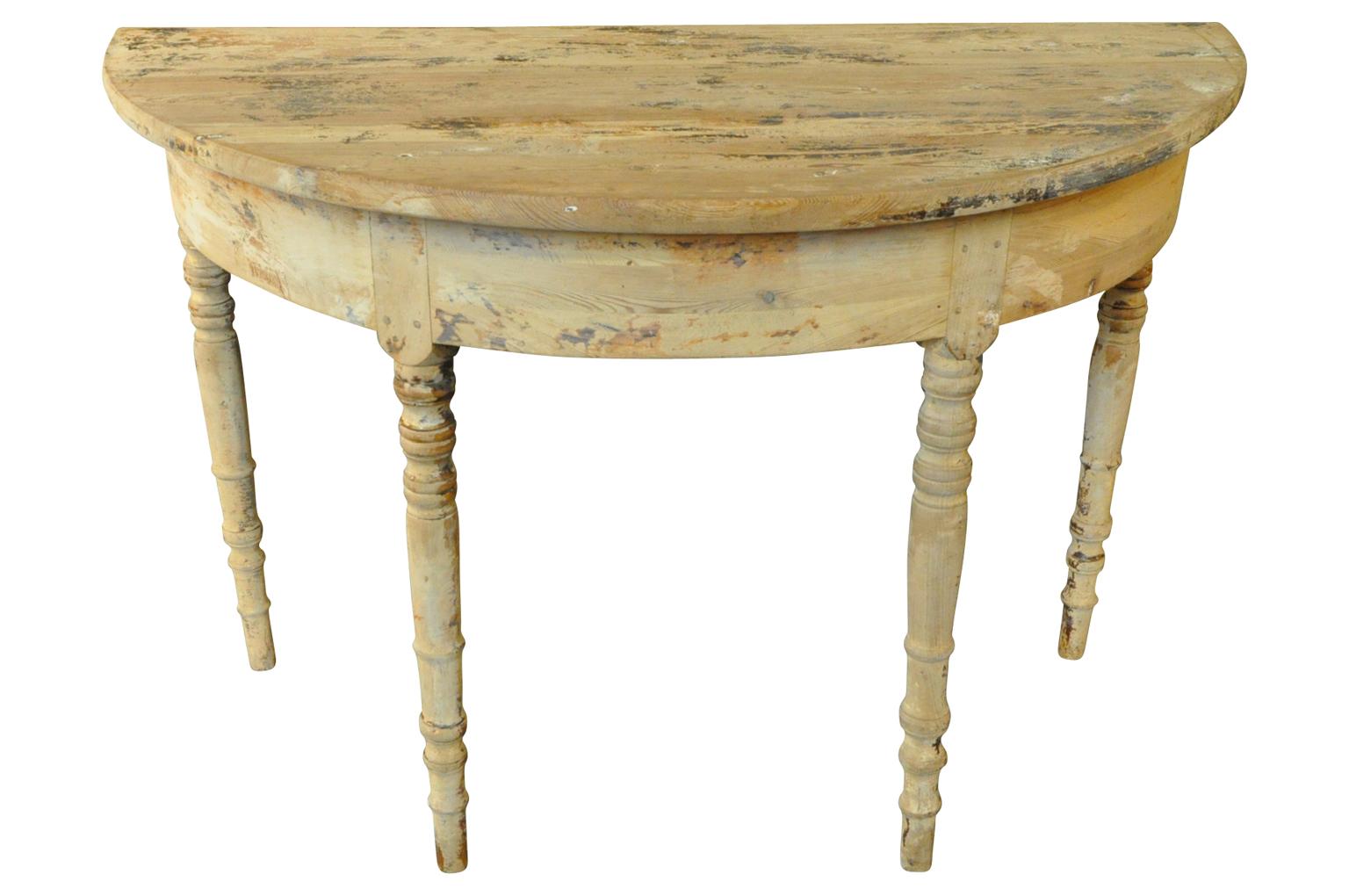 A very charming later 19th century demilune console table from the South of France. Soundly constructed from painted wood with nicely turned legs.