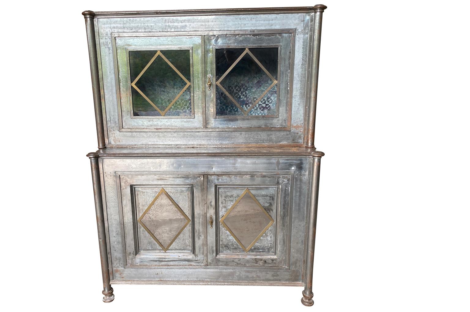 A sensational mid-19th century Deux Corps cabinet soundly constructed from polished steel and brass.  Origining from an estate in Paris.  A terrific accent piece for any kitchen, living area or bedroom.  A super bar cabinet.