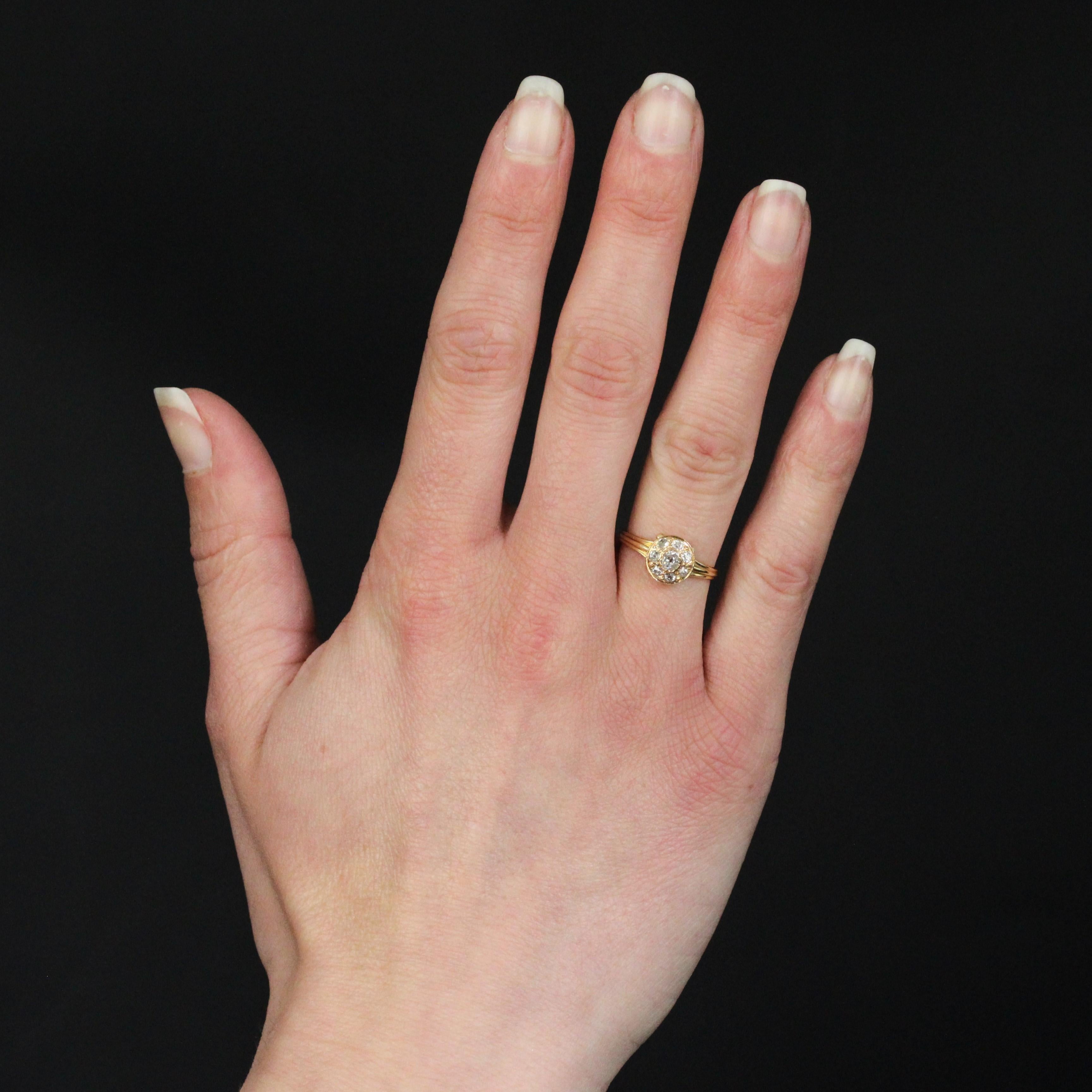 Ring in 18 karat yellow gold, horse head hallmark.
A charming round-shaped antique ring set with antique cushion-cut diamonds, the center one being larger and set with folded claws. Openings have been added to the basket to let the light penetrate