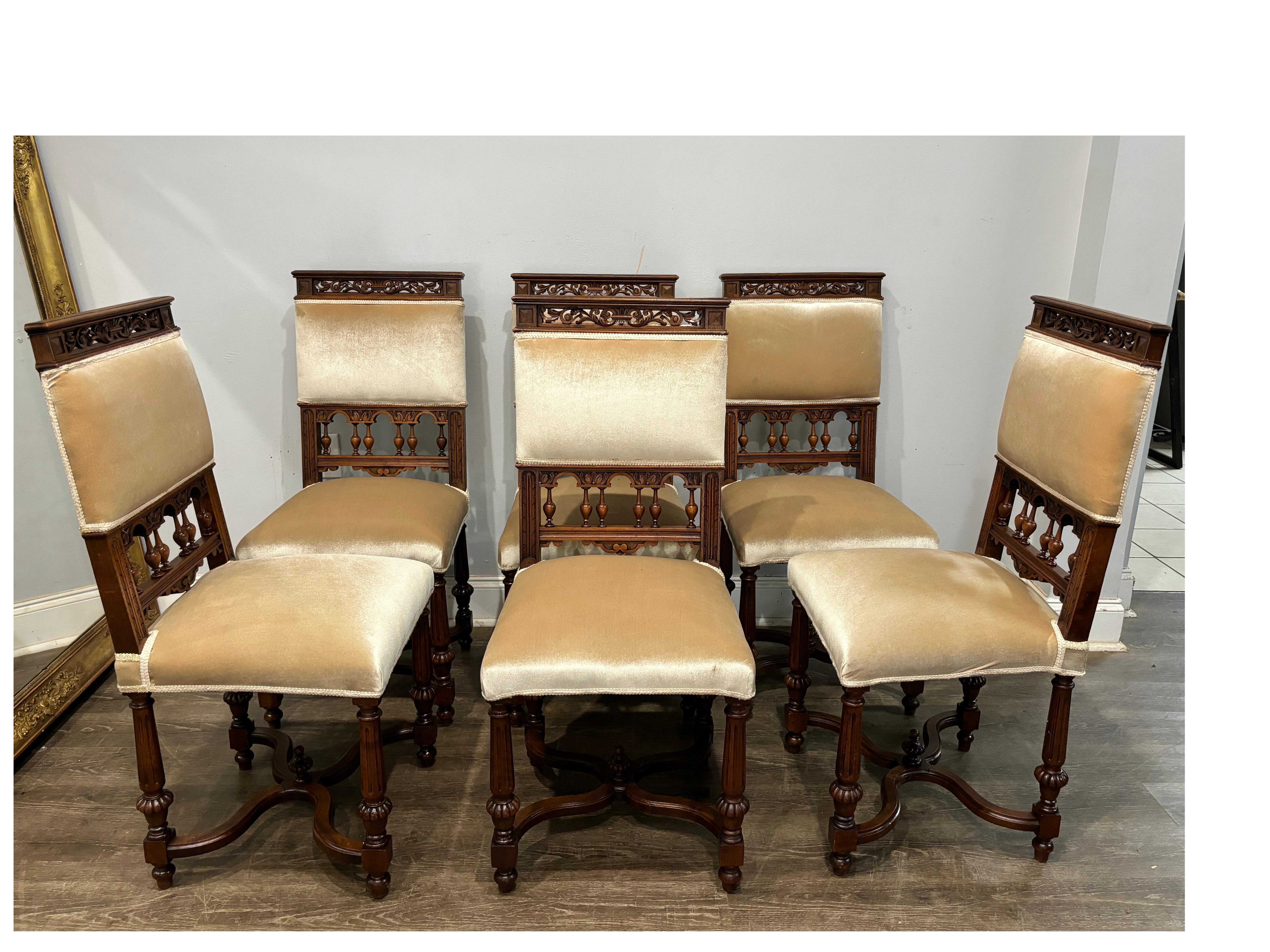 Those chairs are made of walnut and are covered of a beige velvet. They are in the style of Henri II.