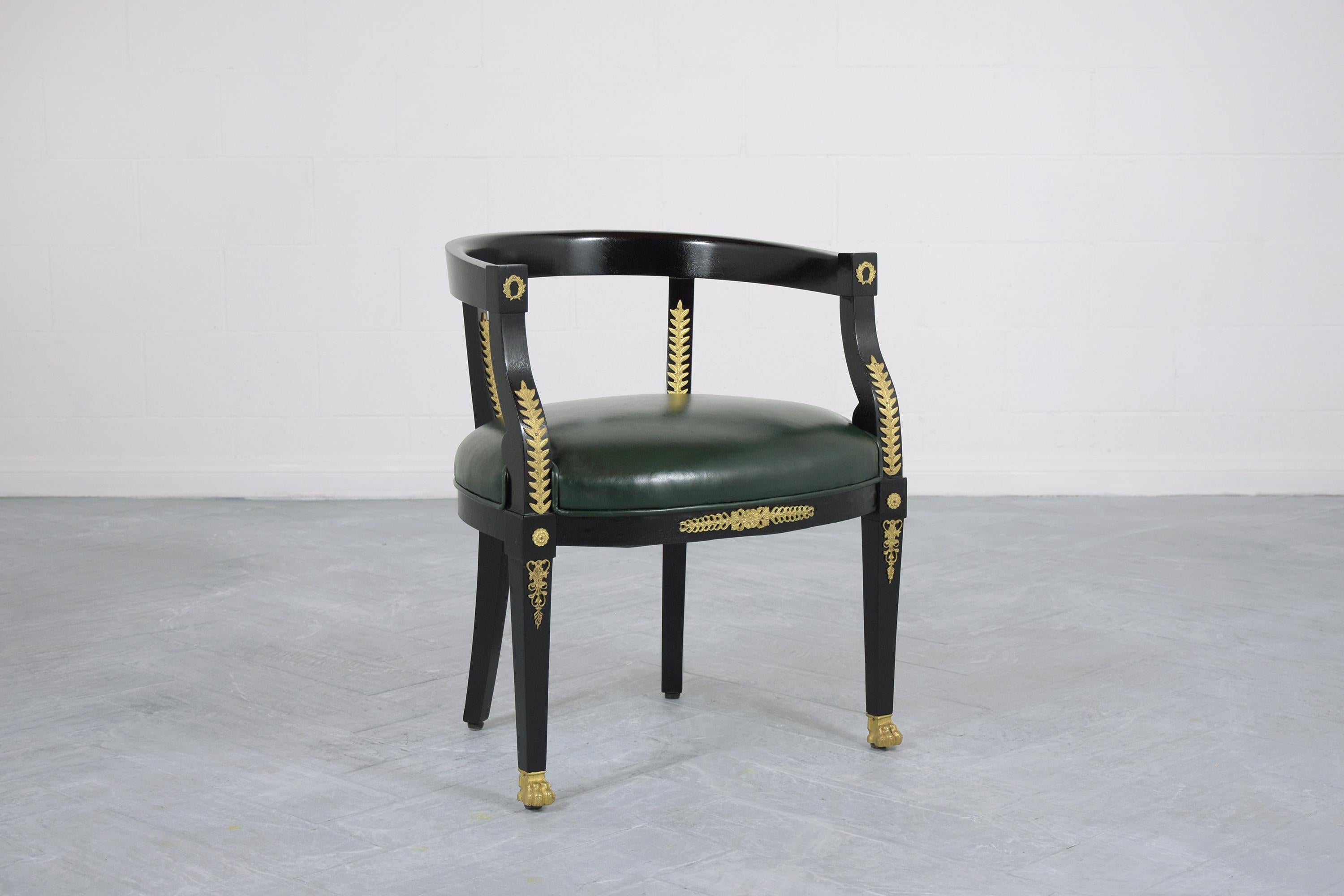 This French 19th-century leather armchair is made out of mahogany wood and has been fully restored by our team of expert craftsmen. The armchair has been professionally restained in ebonized color with a lacquered finish, features finely carved