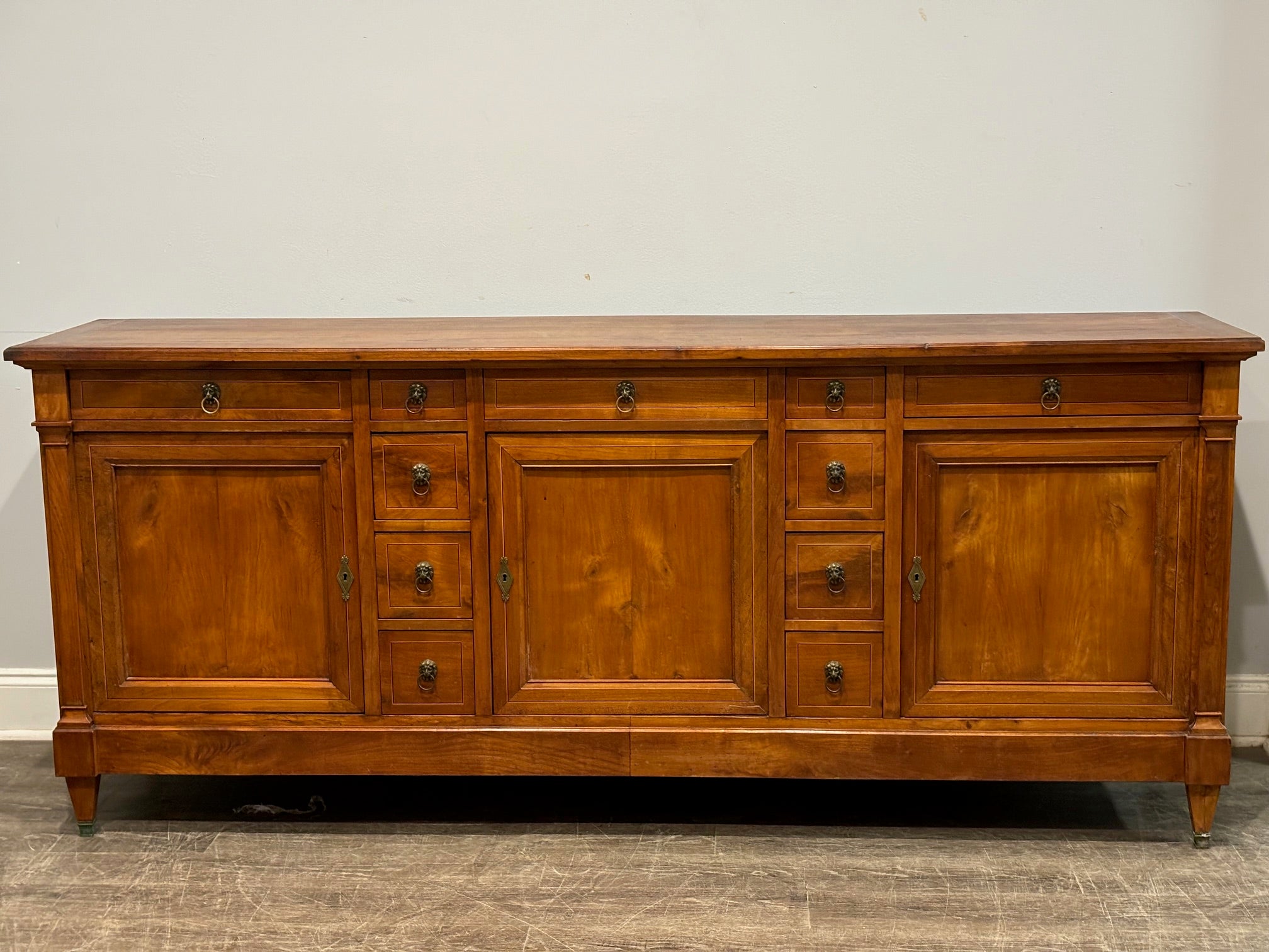 This is a beautiful sideboard in walnut with inlay on the top, doors and drawers, very refine.