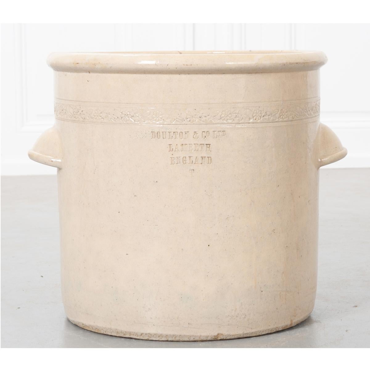 A late 19th century, Doulton & Company, cream color glazed stoneware jar of large proportions. You will find stamped on the side of the jar “Doulton & Co. Ltd. Lambeth, England T’. There is also a decorative floral banding and two handles fashioned