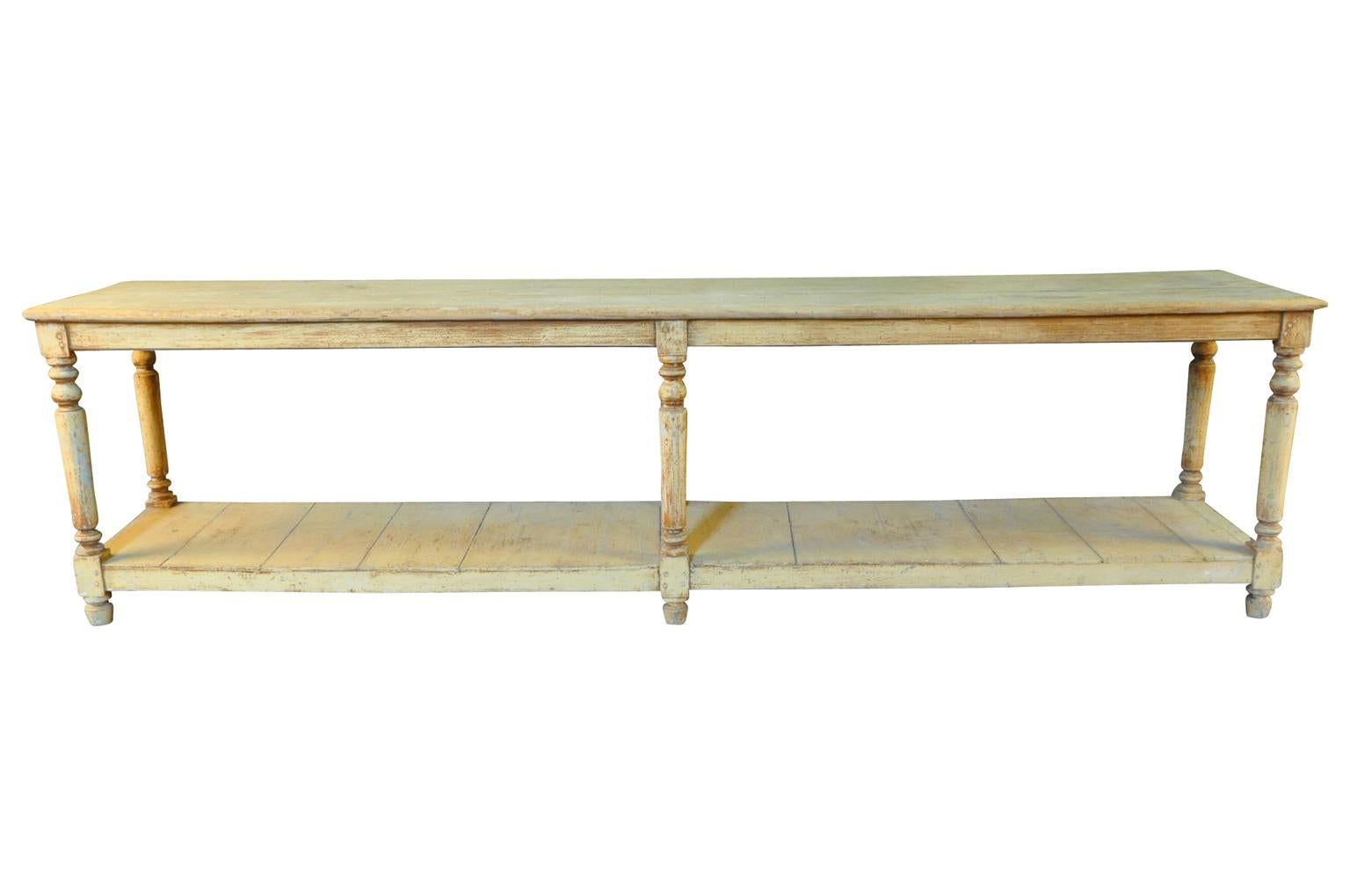 A very lovely later 19th century Draper's Table from the South of France. Soundly constructed from painted wood with beautifully turned legs and a base shelf. Serves wonderfully as a console table, room divider or serving piece. Terrific patina.