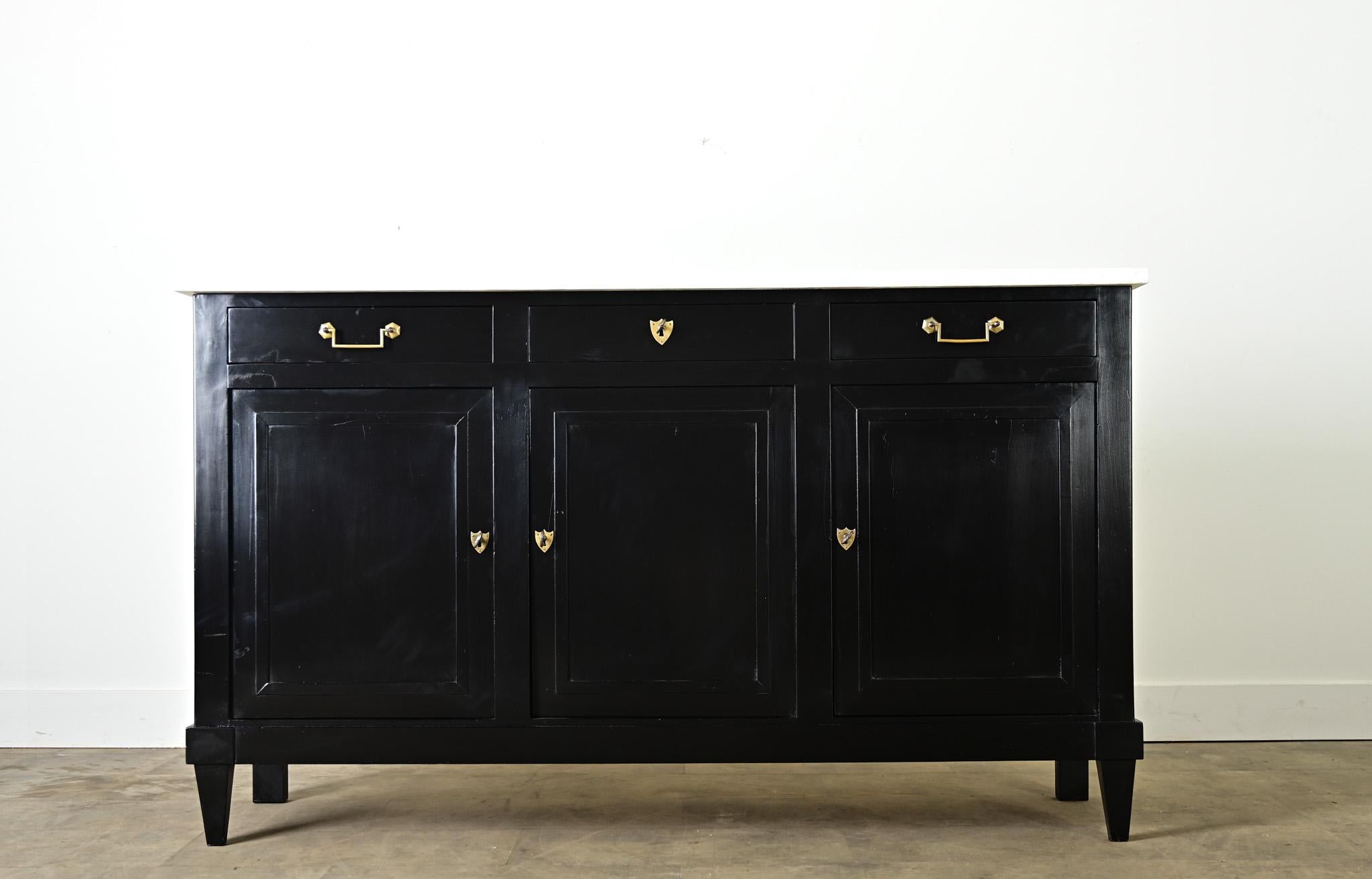 A timeless storage piece for refined and modern tastes, this 19th century French mahogany enfilade has a more recent ebonized finish that beautifully contrasts the white marble top for a touch of drama in a foyer or dining room. The narrow case is