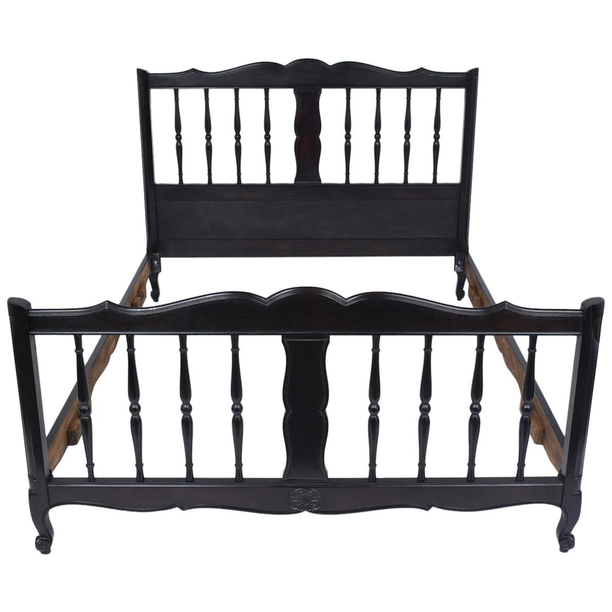 This French Provincial full-size bed frame has been completely restored by our expert craftsmen, is made out of walnut wood, and features a newly stained ebonized satin finish. The frame comes with head/footboard and wooden rails, each has beautiful