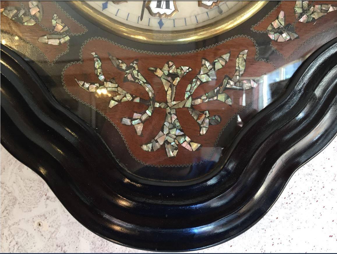 French Napoleon III style ebonized wall clock with mother-of-pearl inlay from 1860s.
The clock has its original mechanism.
We can provide a quotation to make it work restoring its regular winding or replace it with battery operation mechanism